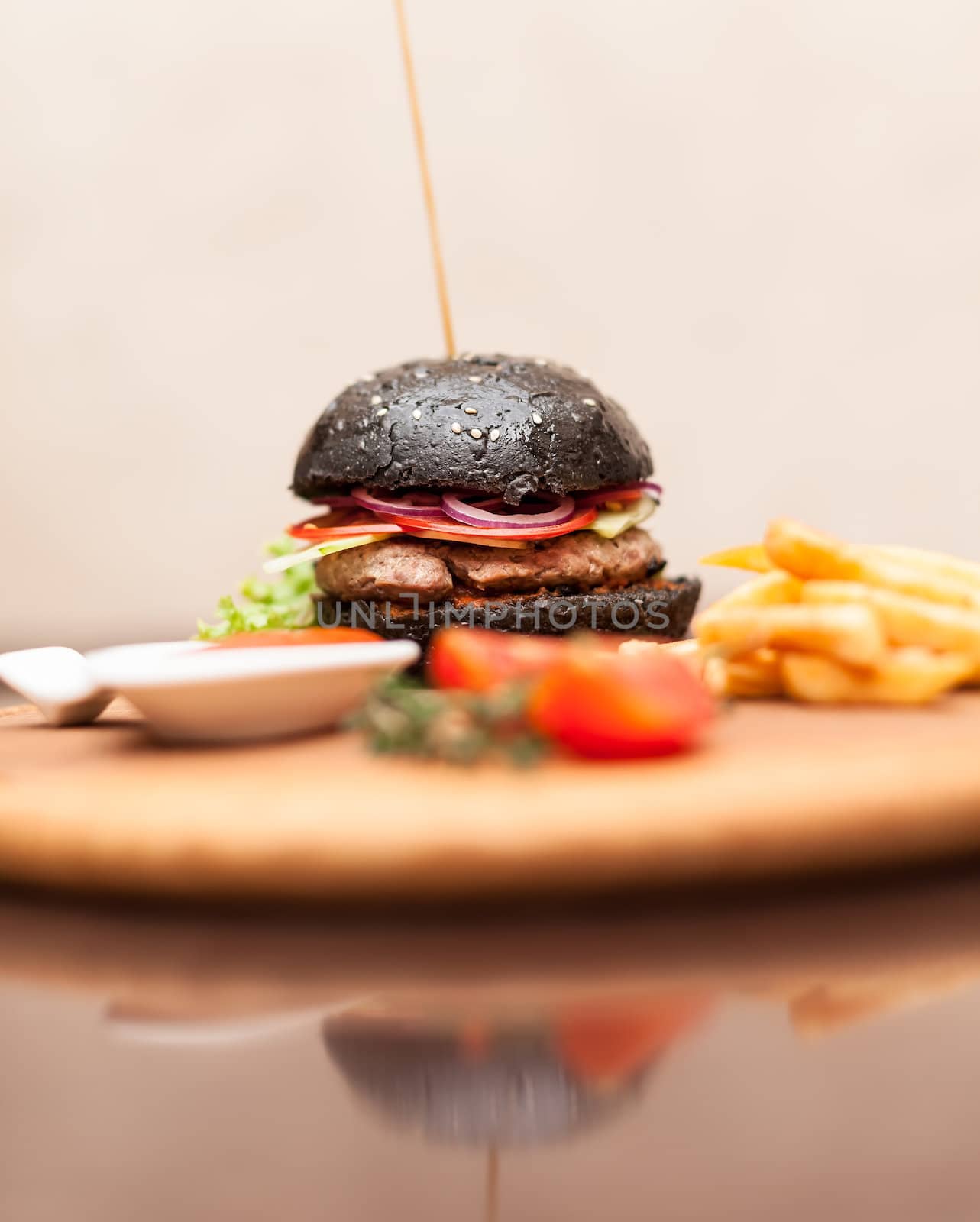 Delicacy. Delicious black hamburger with squid ink. Shallow DOF. Focus on the burger