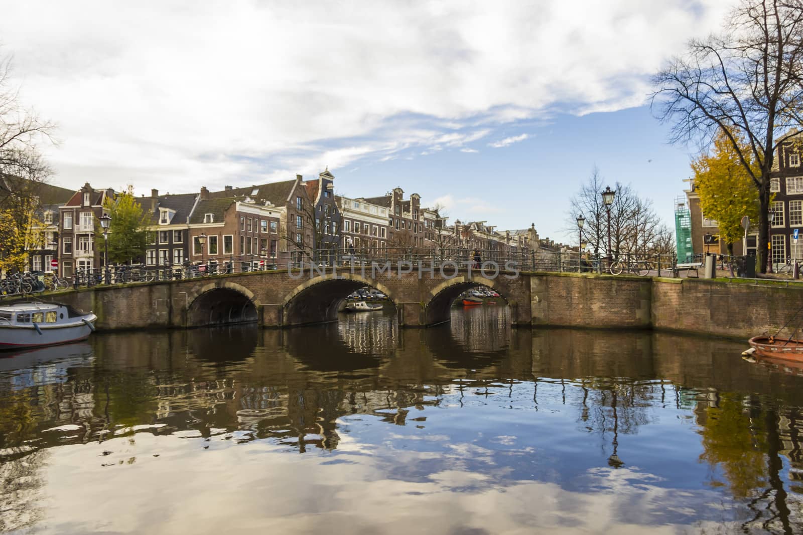View on a canal bridge in Amsterdam in late autumn by Tetyana