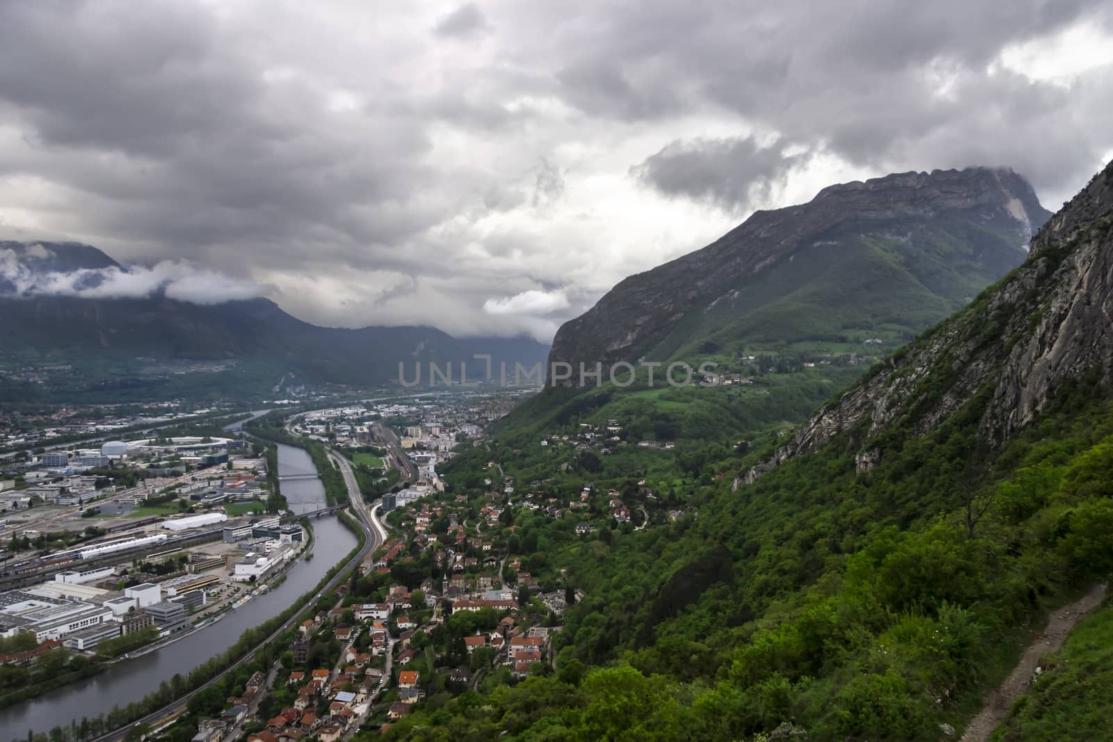 panorama of Grenoble with Alps and deep clouds in background