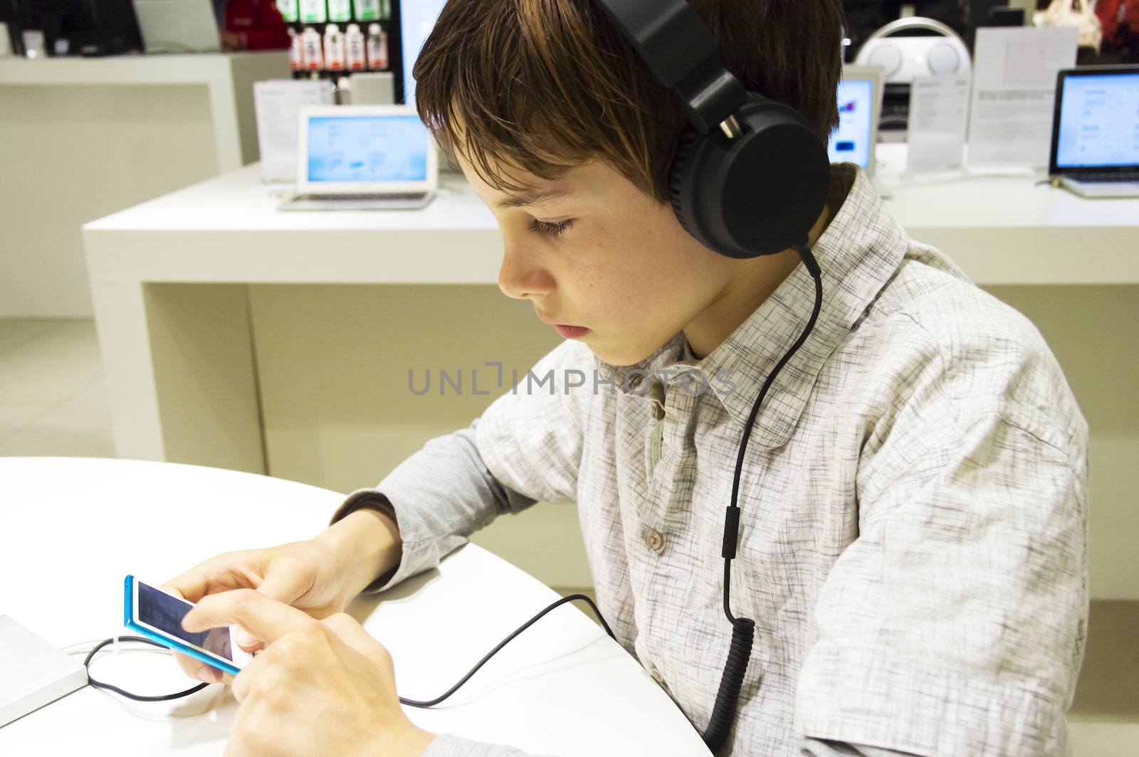 Portrait of a sweet young boy listening to music on headphones