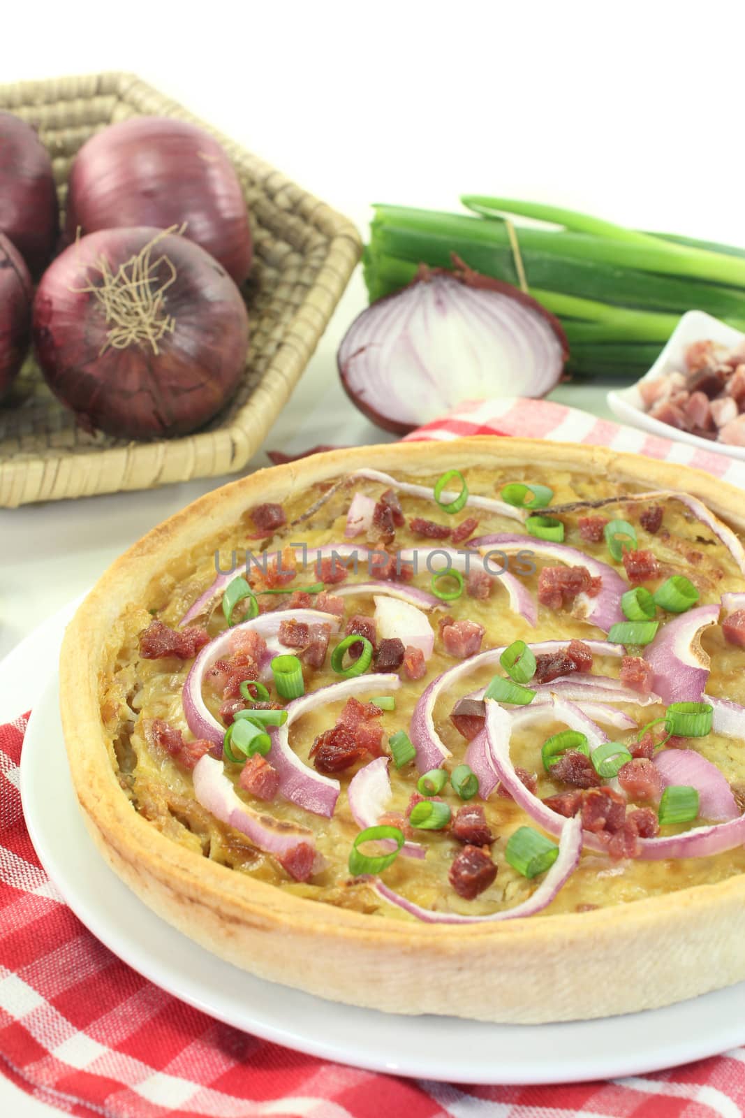 freshly baked onion tart with ham cubes