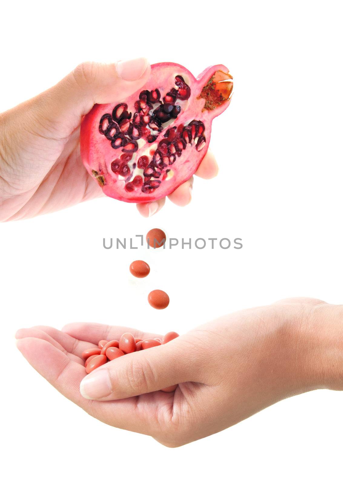 Conceptual image of vitamin tablets being squeezed out of a pomegranate fruit, a powerful antioxidant 