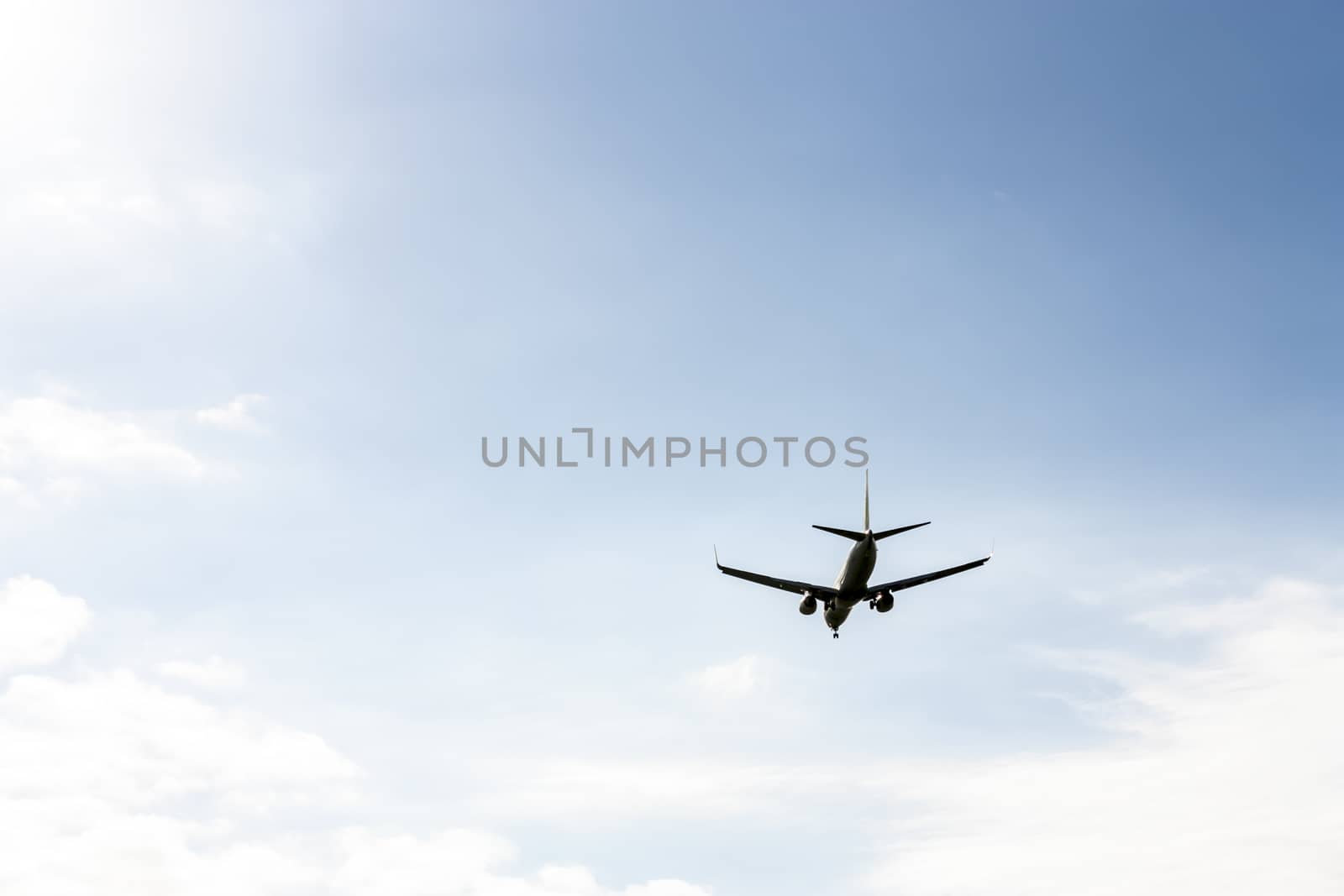 airplane flying at blue sky by Tetyana