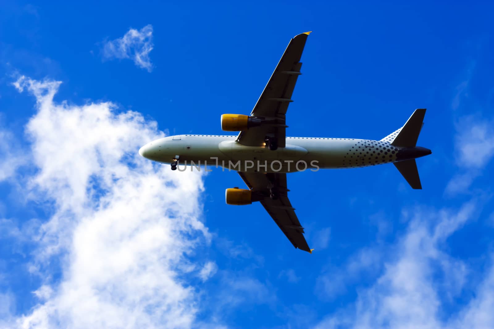 airplane flying at blue sky by Tetyana
