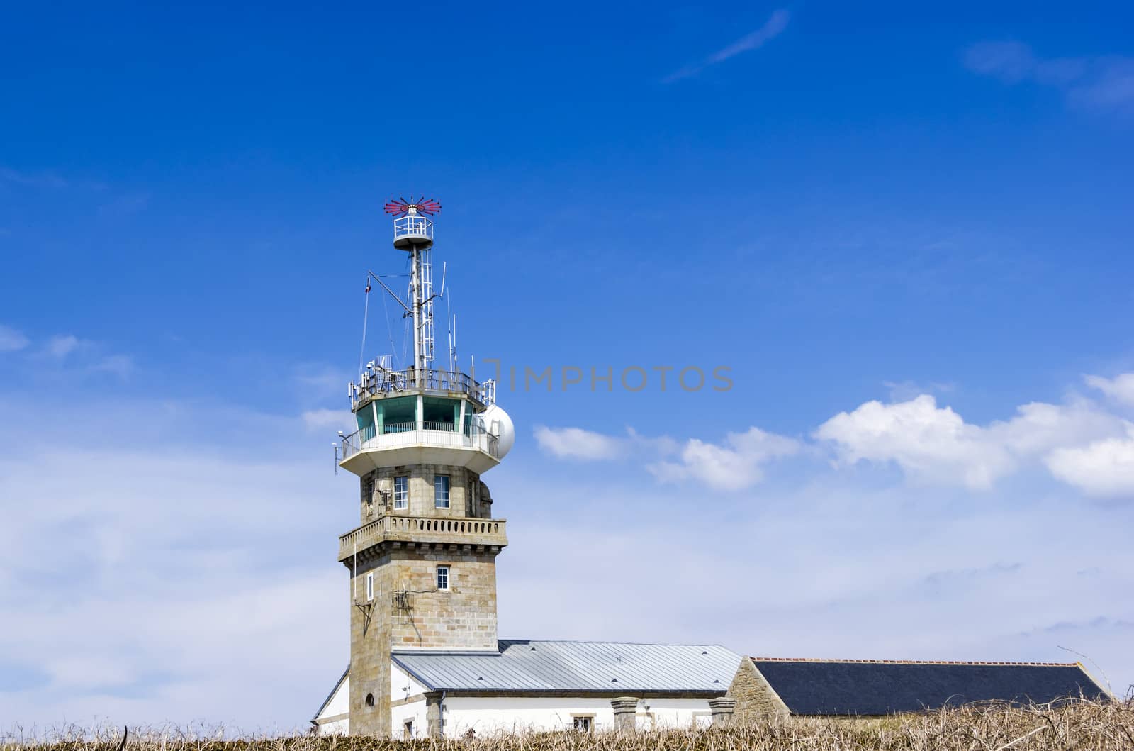 Old stone lighthouse with modern equipment, Cape Ra, (Pointe du Raz), westernmost France point