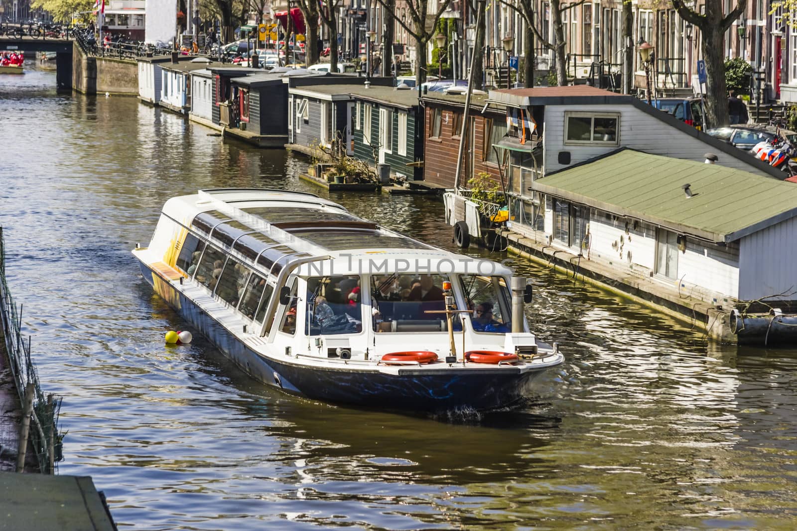 View on the houseboats with cruiseboat in Amsterdam the Netherlands