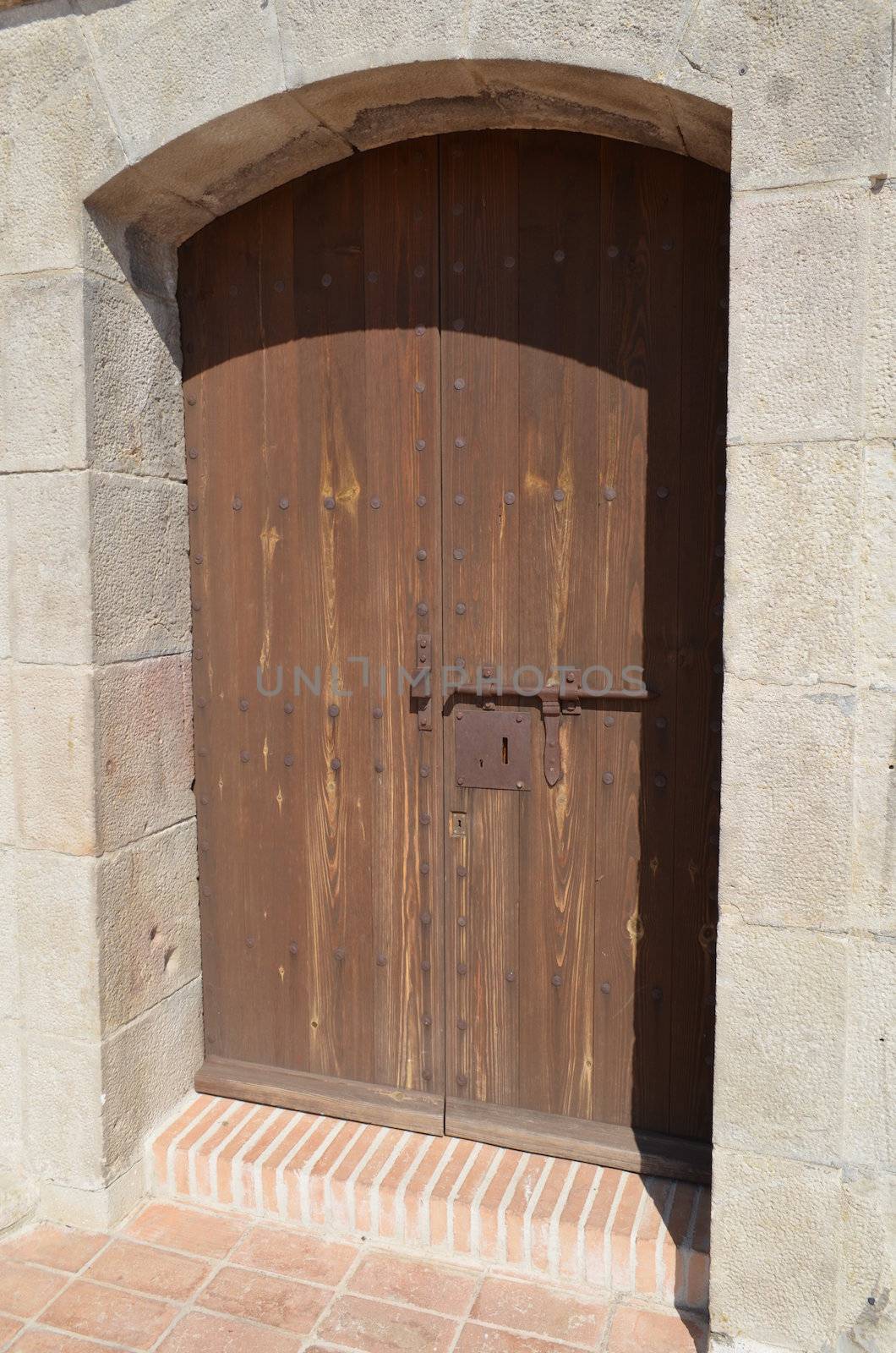 Wooden door and stone surround on a Spanish fortress in Barcelona,Spain.