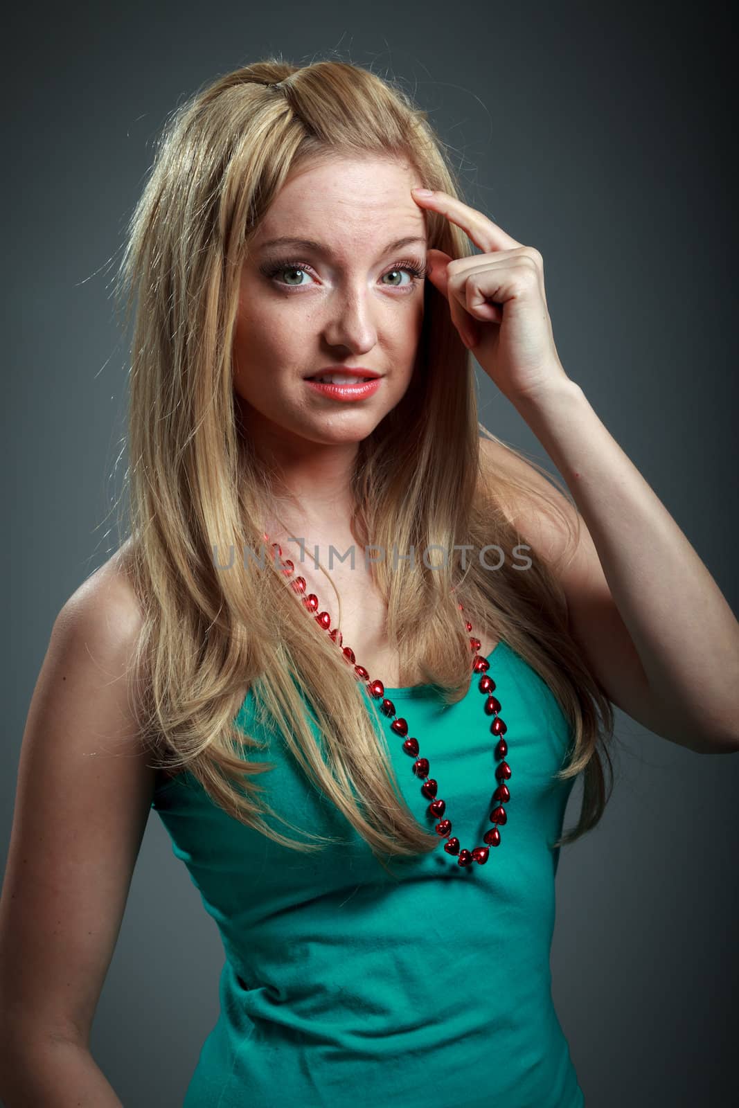 Attractive caucasian blond girl isolated on a grey background