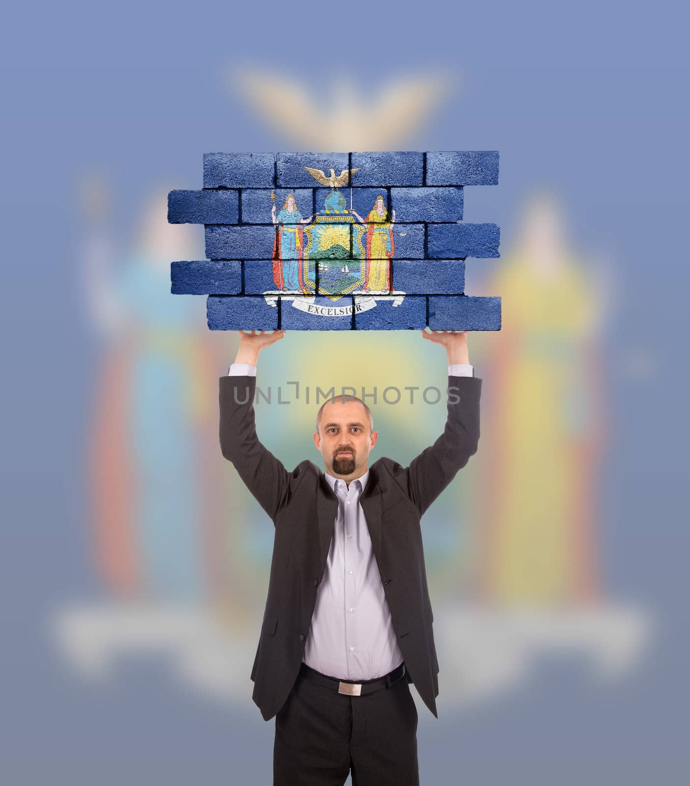 Businessman holding a large piece of a brick wall, flag of New York, isolated on national flag