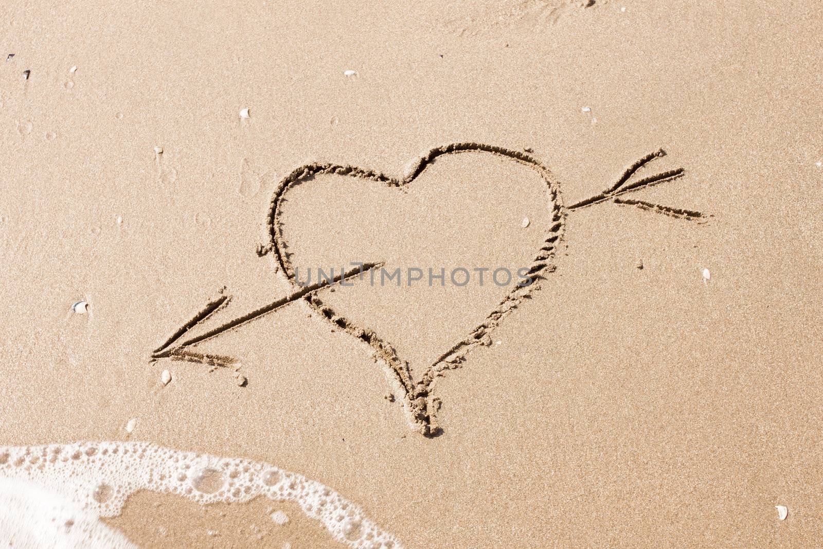 heart with an arrow written on the sand by RTsubin