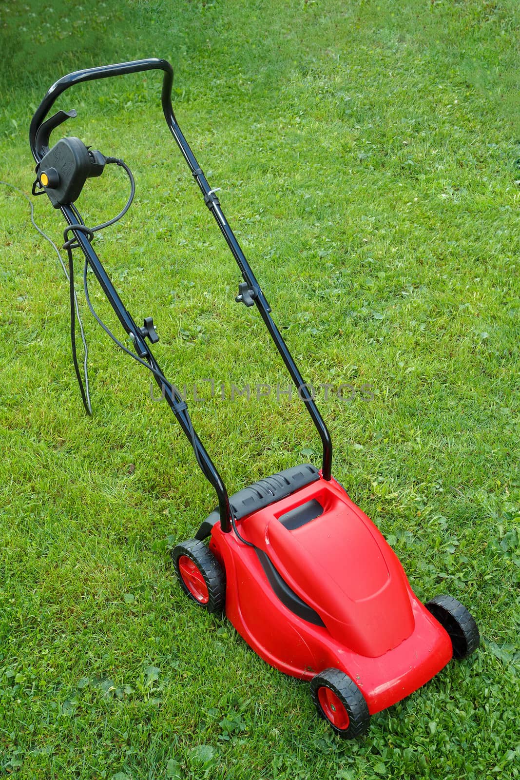  new lawnmower on green grass in cloudy day