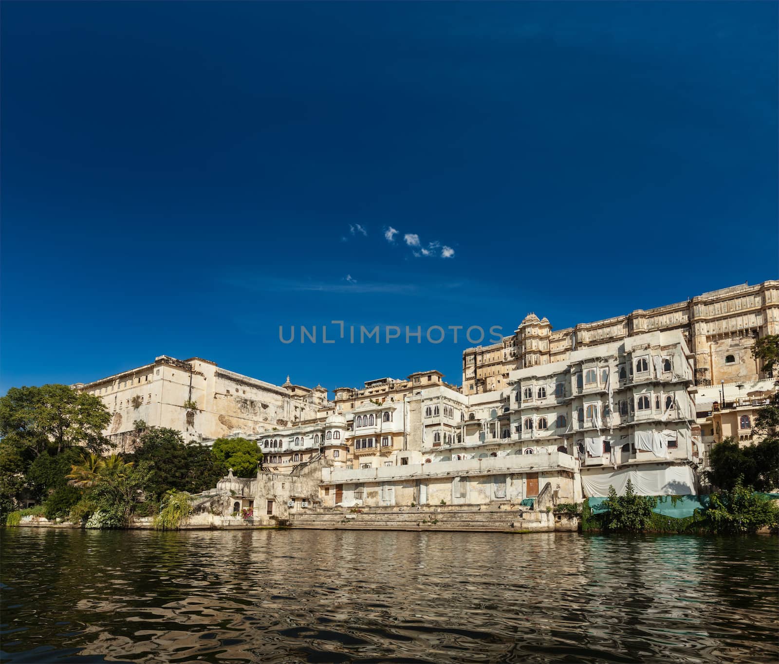 India luxury tourism concept background - Udaipur City Palace from Lake Pichola. Udaipur, Rajasthan, India