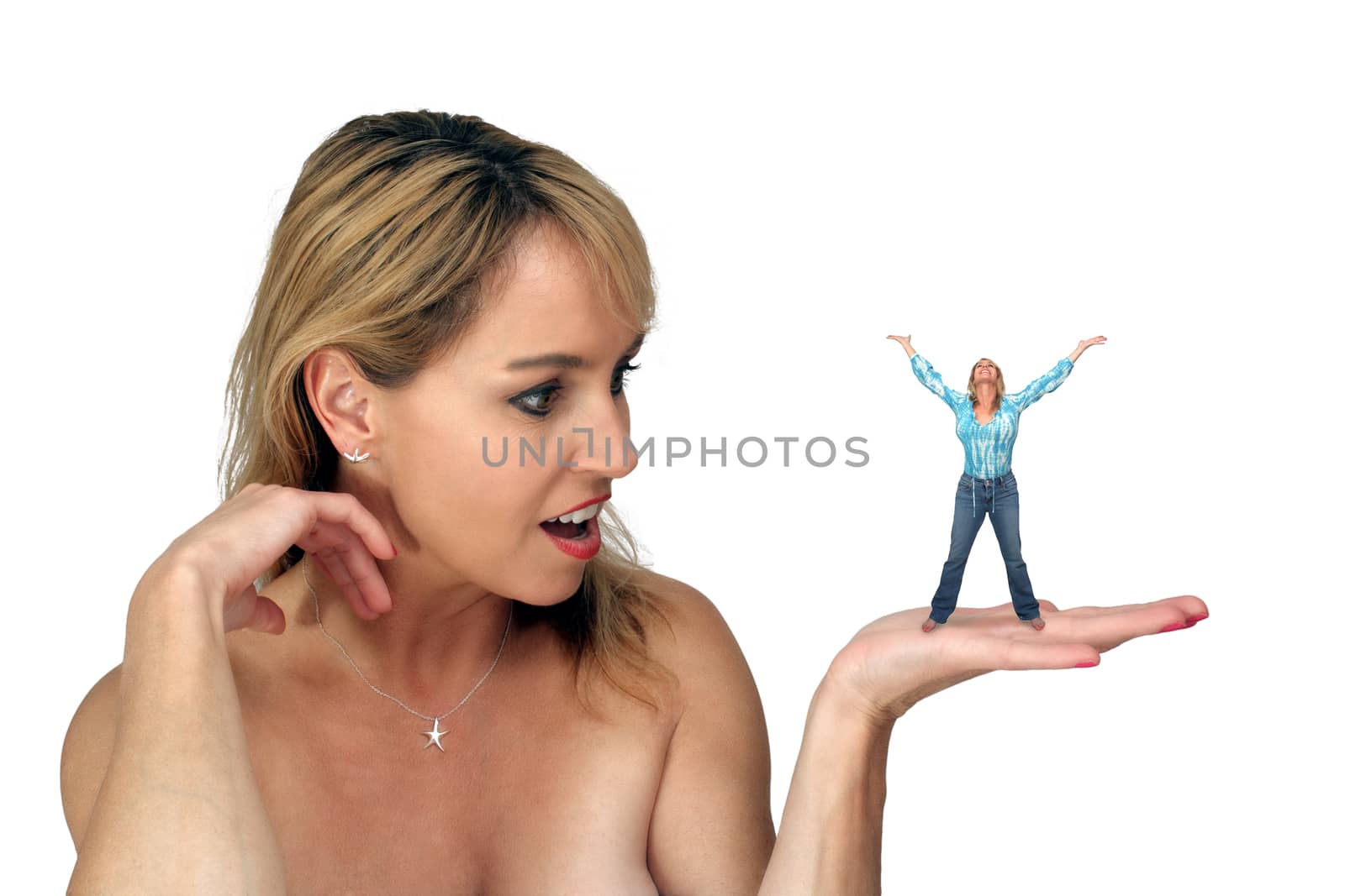 A lovely blonde with bare shoulders, holding her miniature self in her hand, with an excited or surprised facial expression.