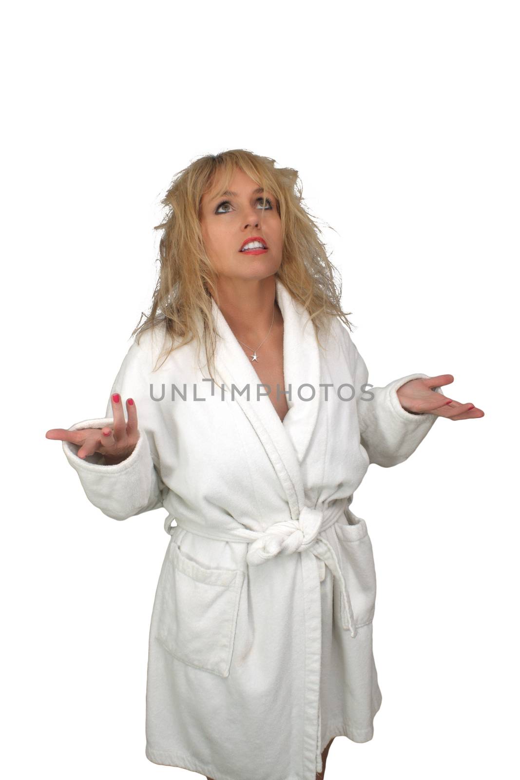 A lovely blonde with frizzed hair and wearing a white bathrobe looks discouraged.  Isolated on a white background.