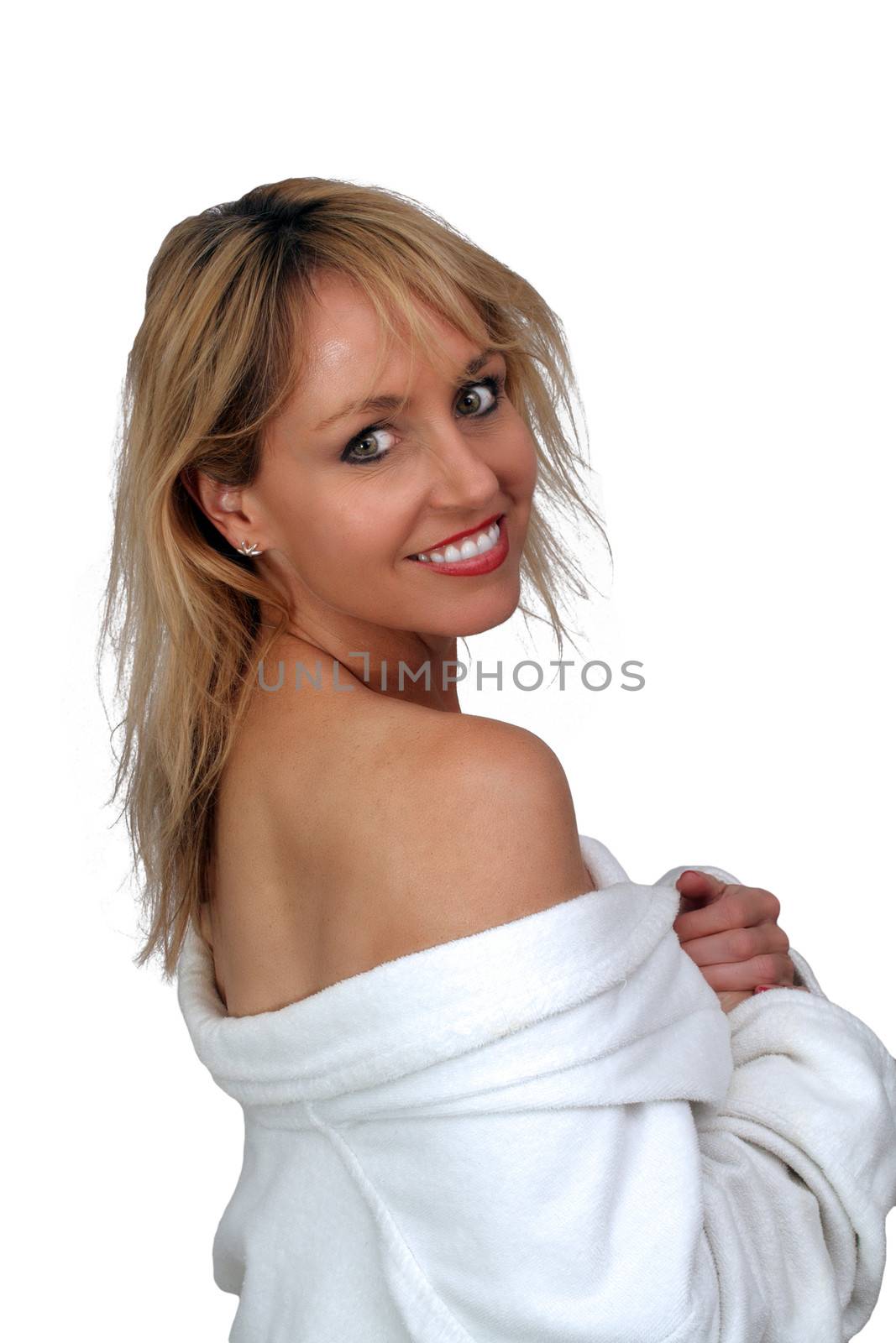 A lovely blonde with a white bathrobe off her shoulders and a captivating smile.  Isolated on a white background.