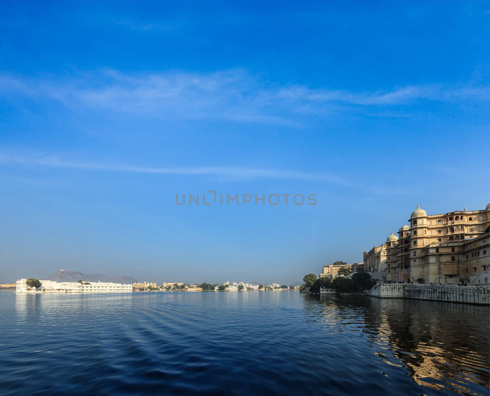 Romantic India luxury tourism concept background - Udaipur City Palace, Lake Palace and Lake Pichola. Udaipur, Rajasthan, India