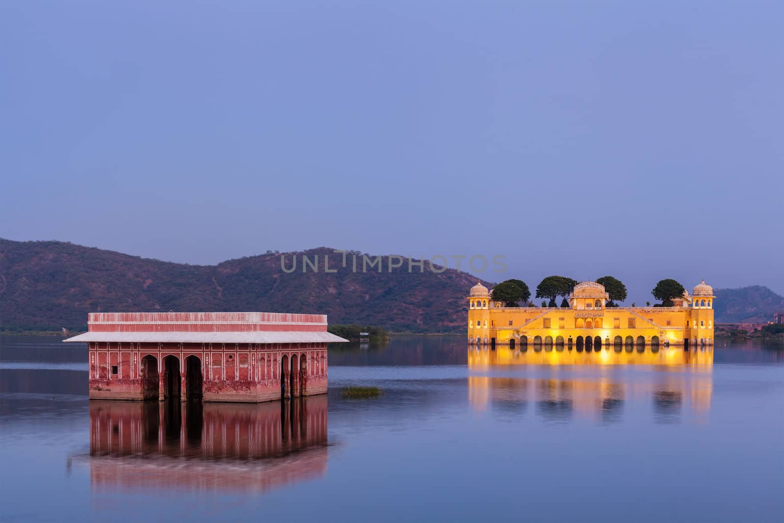 Rajasthan landmark - Jal Mahal (Water Palace) on Man Sagar Lake in the evening in twilight.  Jaipur, Rajasthan, India