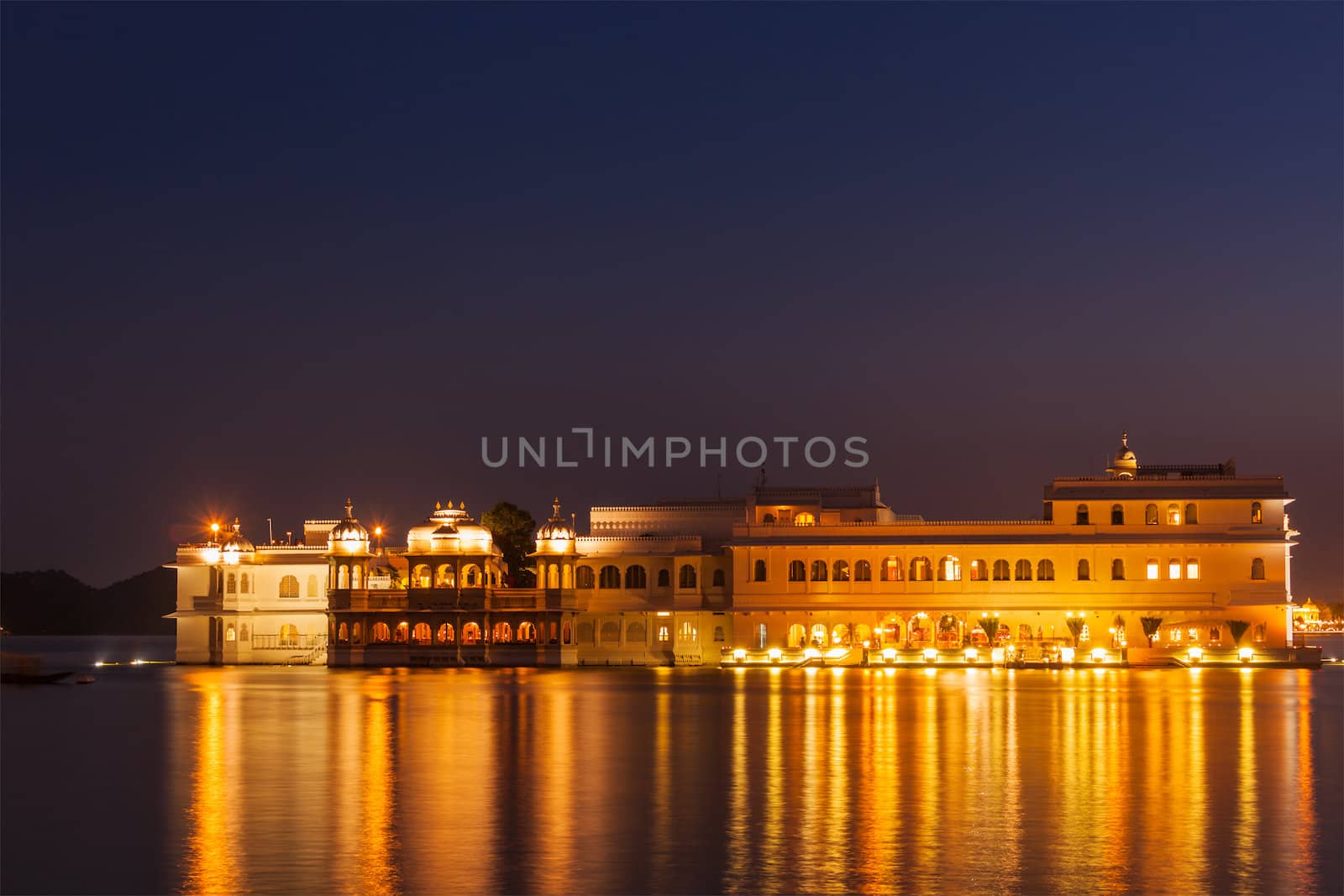 Romantic luxury India travel tourism - Lake Palace (Jag Niwas) complex on Lake Pichola in twilight, Udaipur, Rajasthan, India