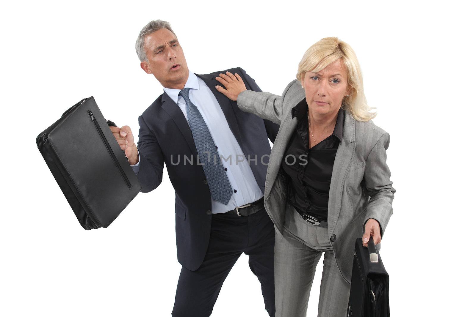 Two businesspeople pushing past each other