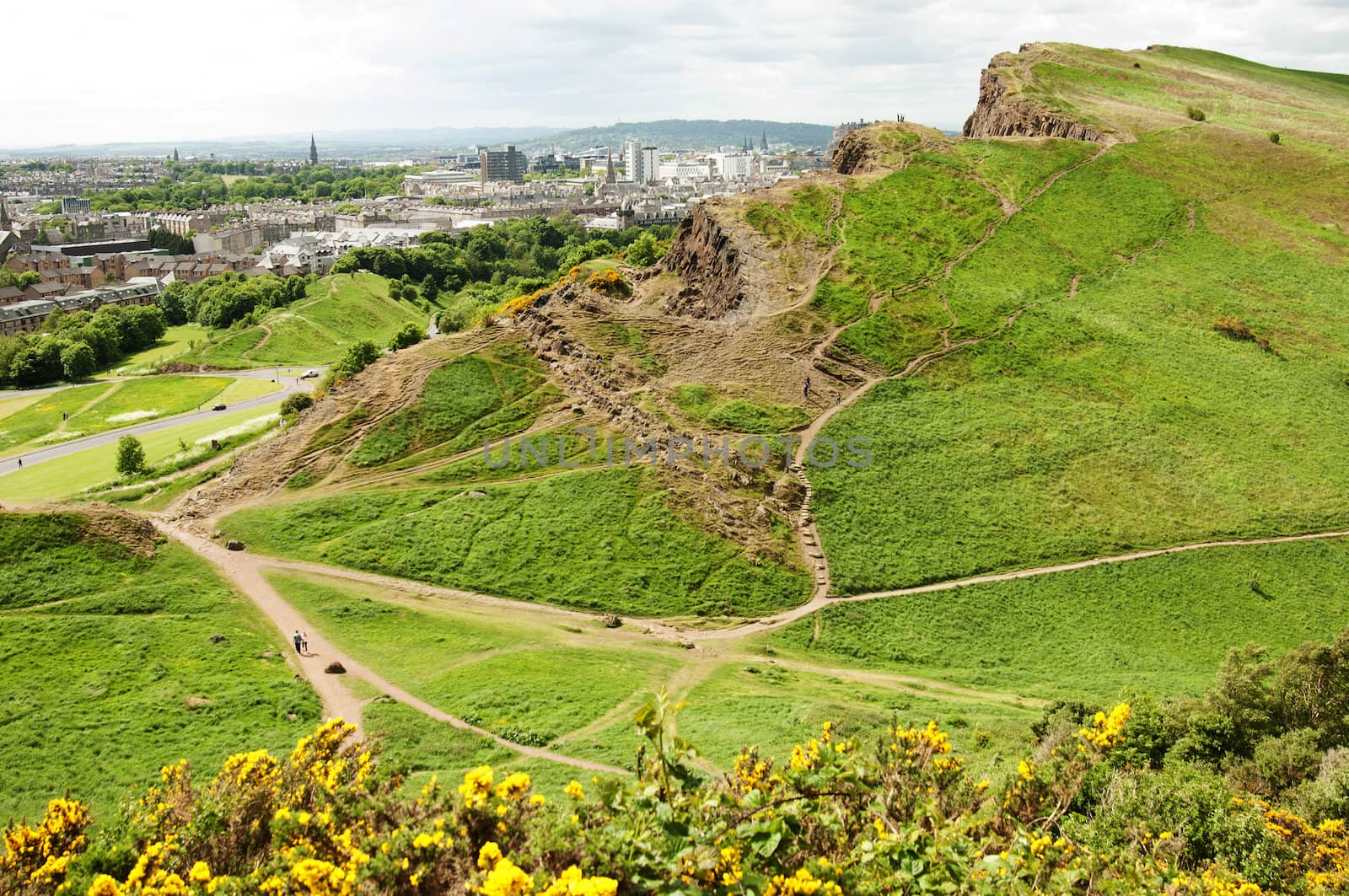 Arthur's Seat is the main peak of the group of hills which form most of Holyrood Park. It is situated in the centre of the city of Edinburgh, about a mile to the east of Edinburgh Castle. The hill rises above the city to a height of 250.5 m (822 ft), provides excellent panoramic views of the city, is relatively easy to climb, and is popular for hillwalking.