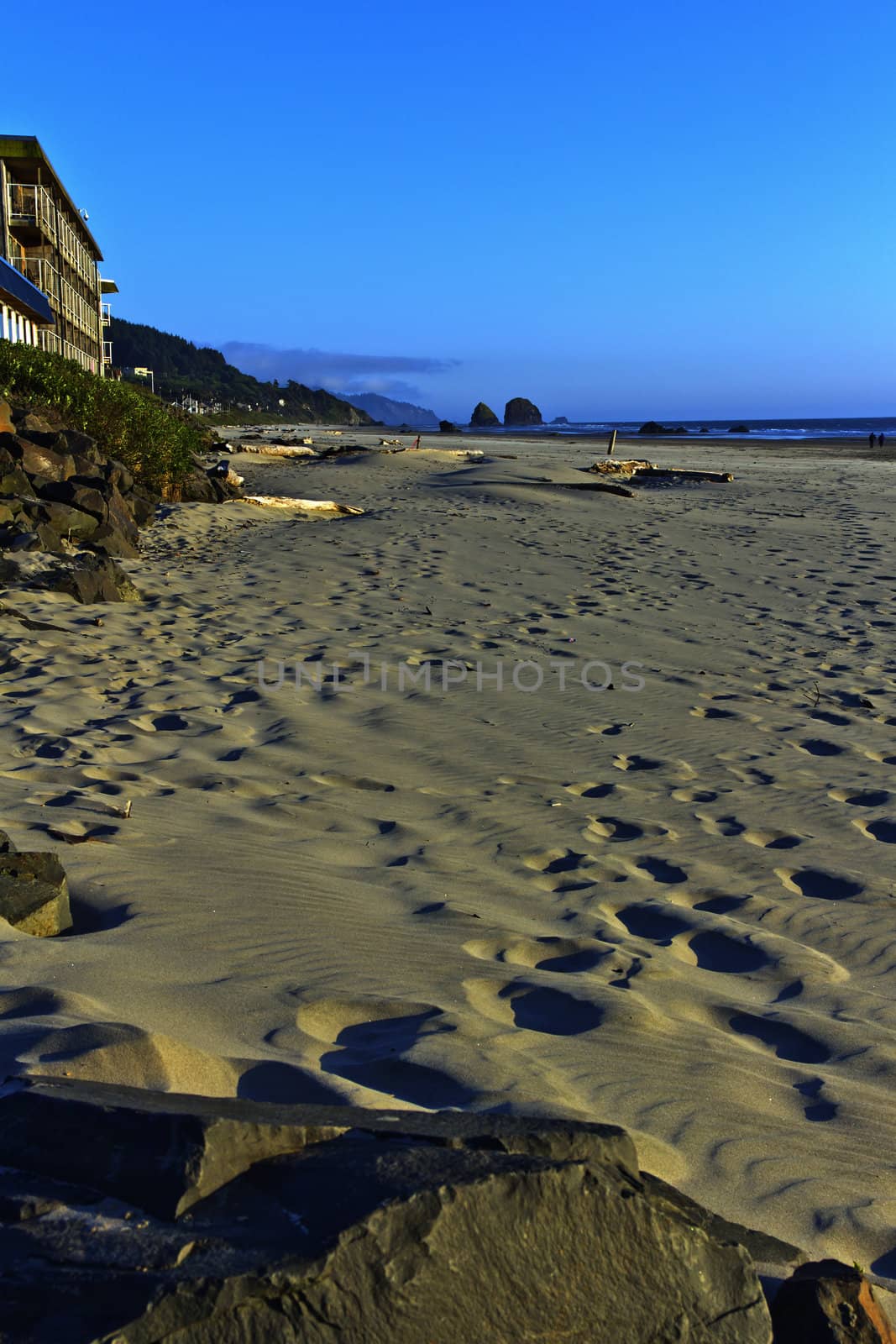 Sand foot-prints in Cannon beach Oregon. by Rigucci