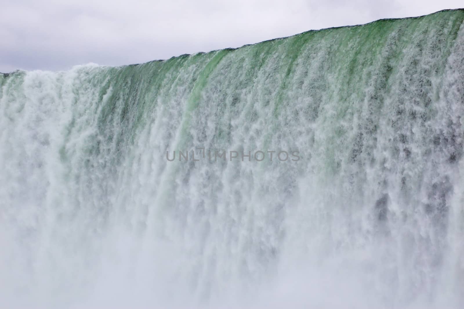 Blue-green water, falling down from Niagara falls.
