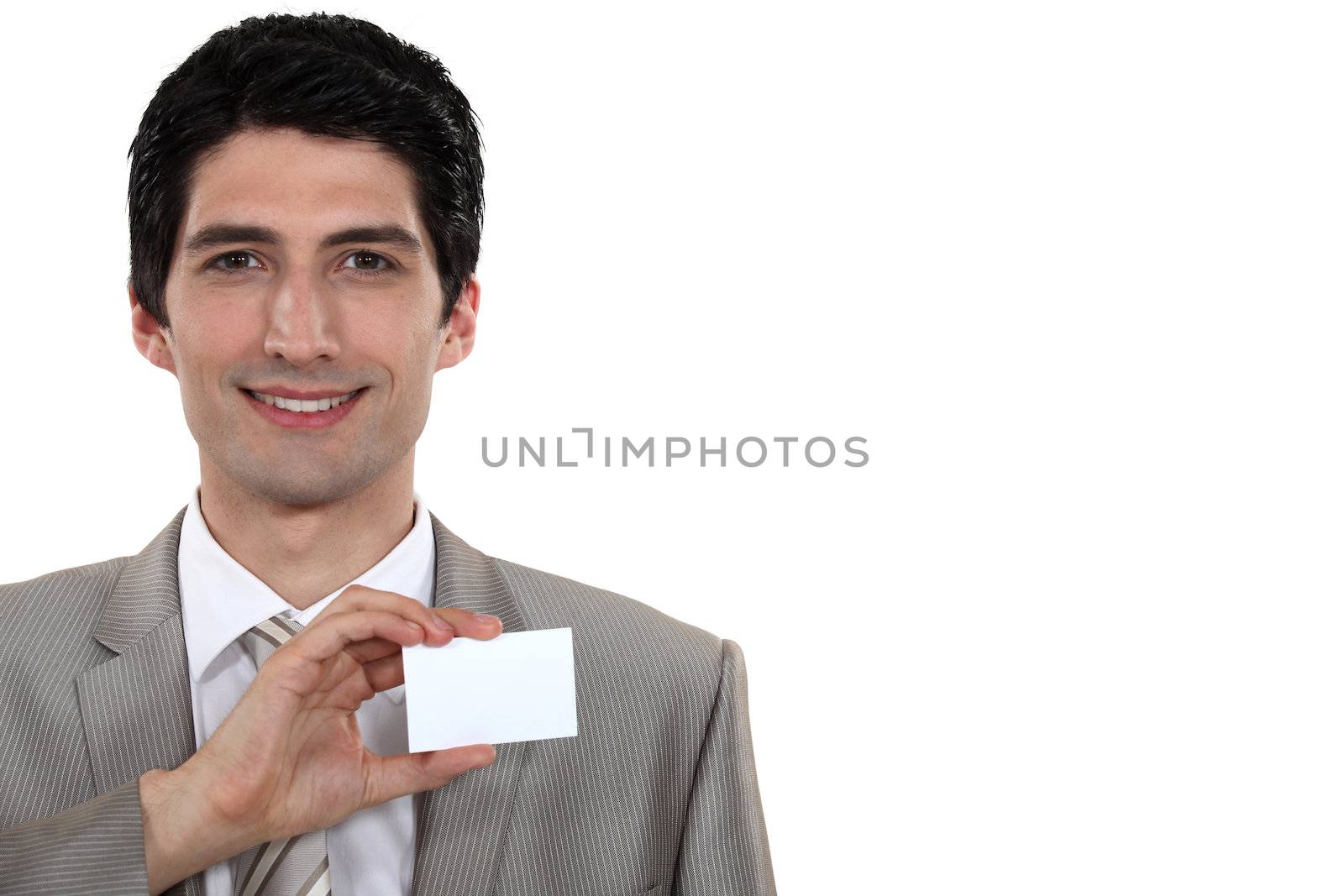Businessman holding up his business card by phovoir