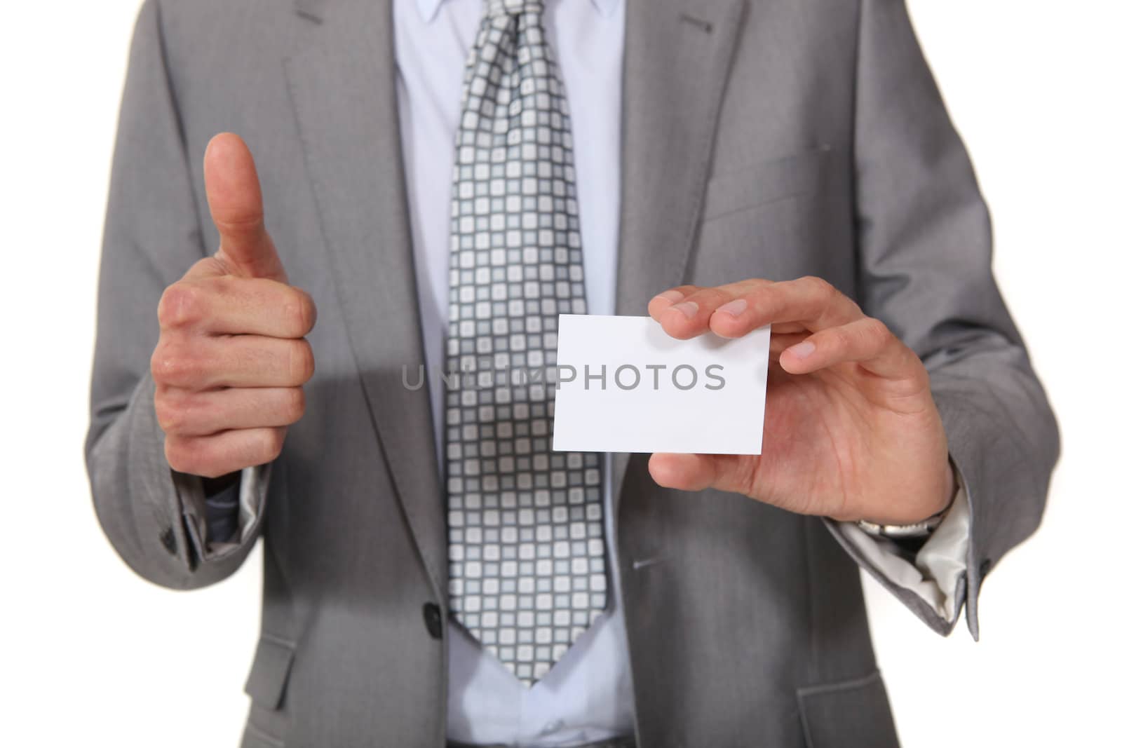 Businessman giving the thumbs up as her displays business card by phovoir