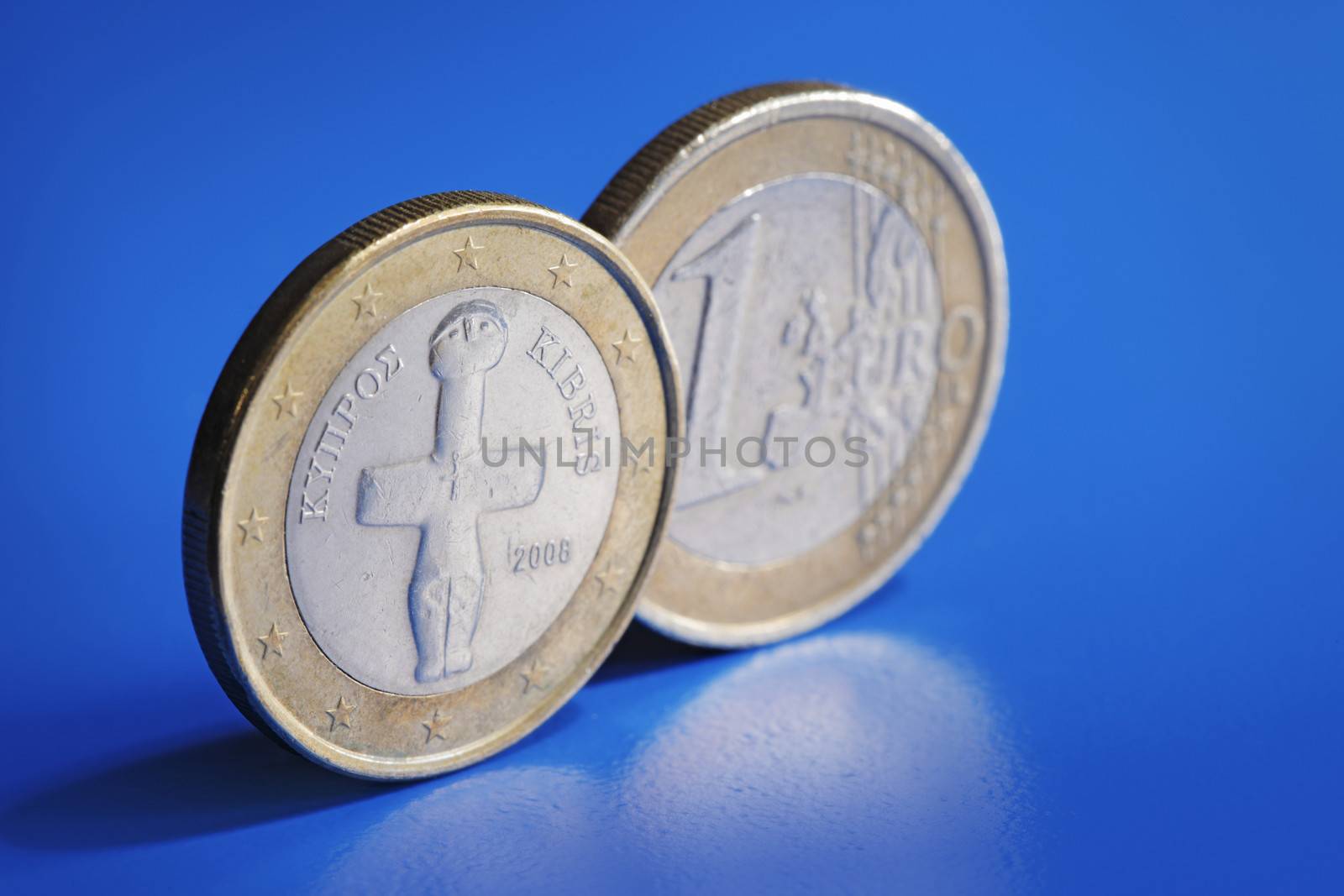 Euro coins from Cyprus on blue background.