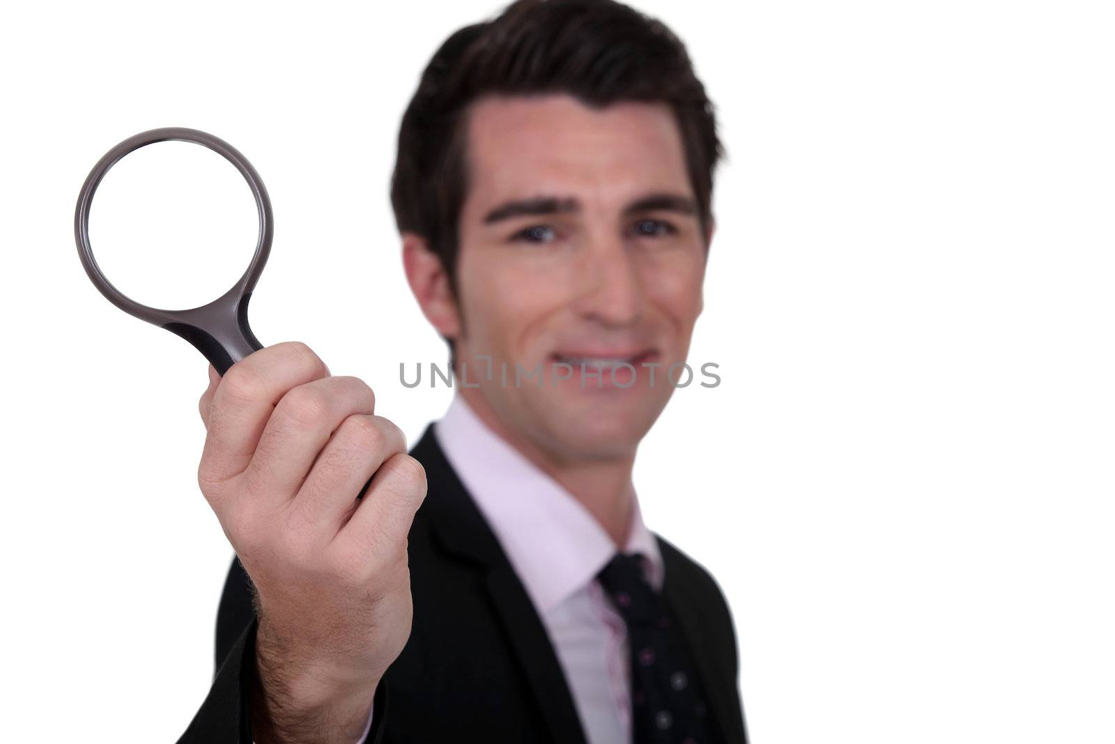 detective holding magnifying glass isolated on whiet by phovoir