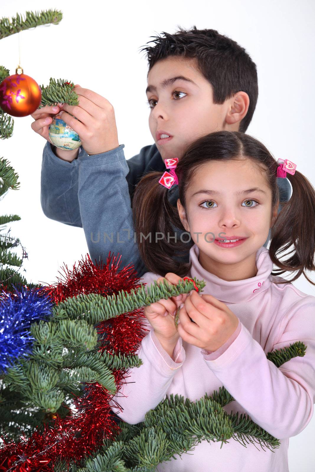 children decorating Christmas tree