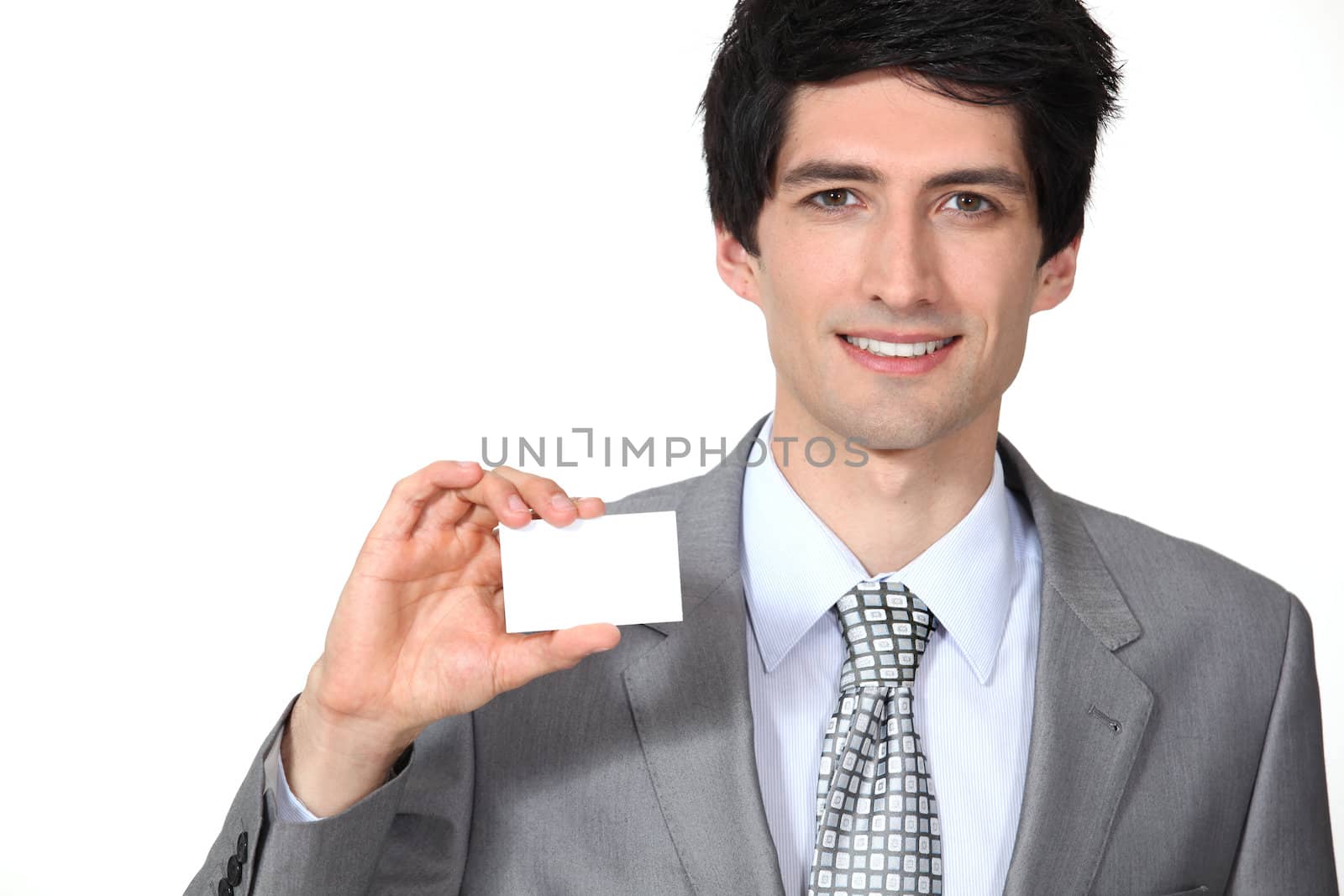 Executive with a blank business card by phovoir