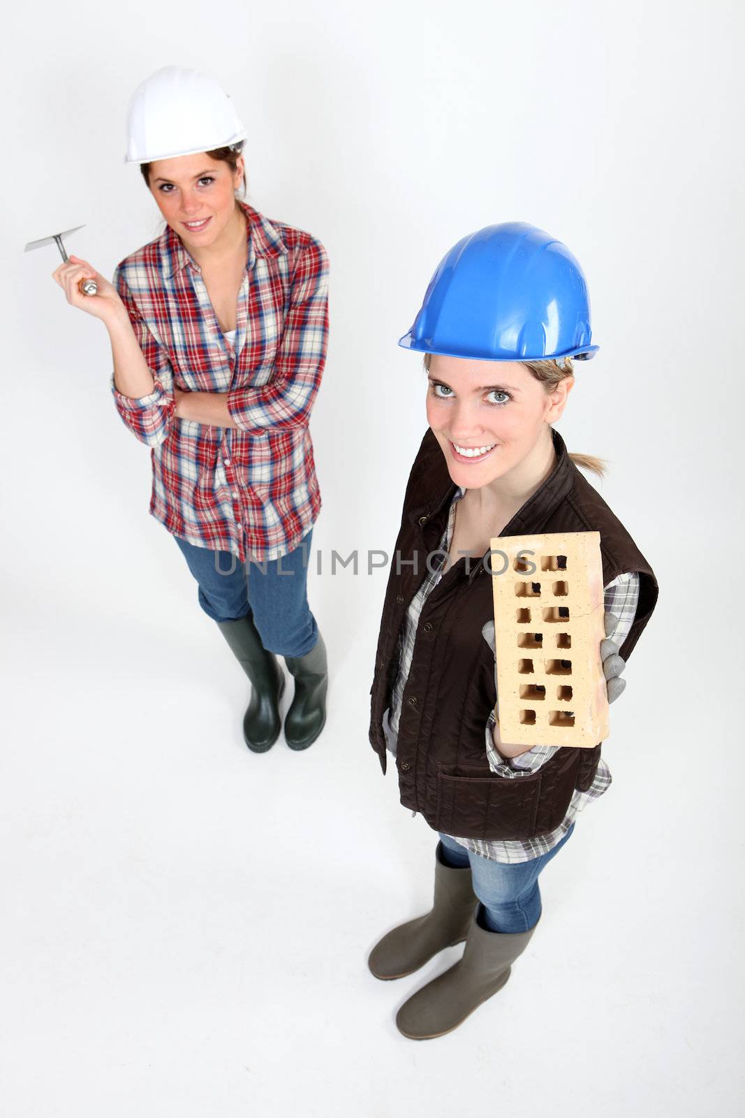 Women with trowel and brick by phovoir