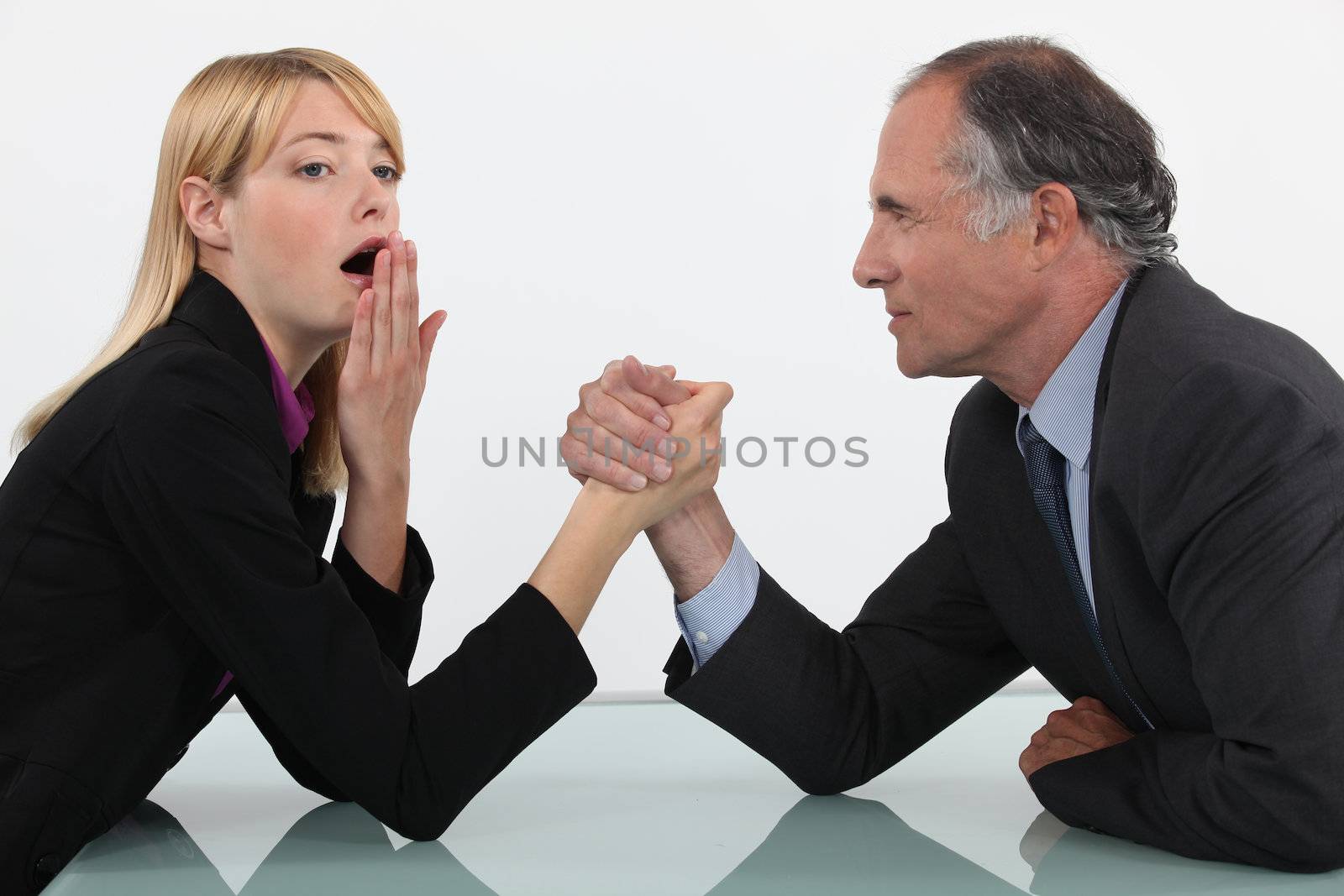 Blond woman arm wrestling her boss by phovoir