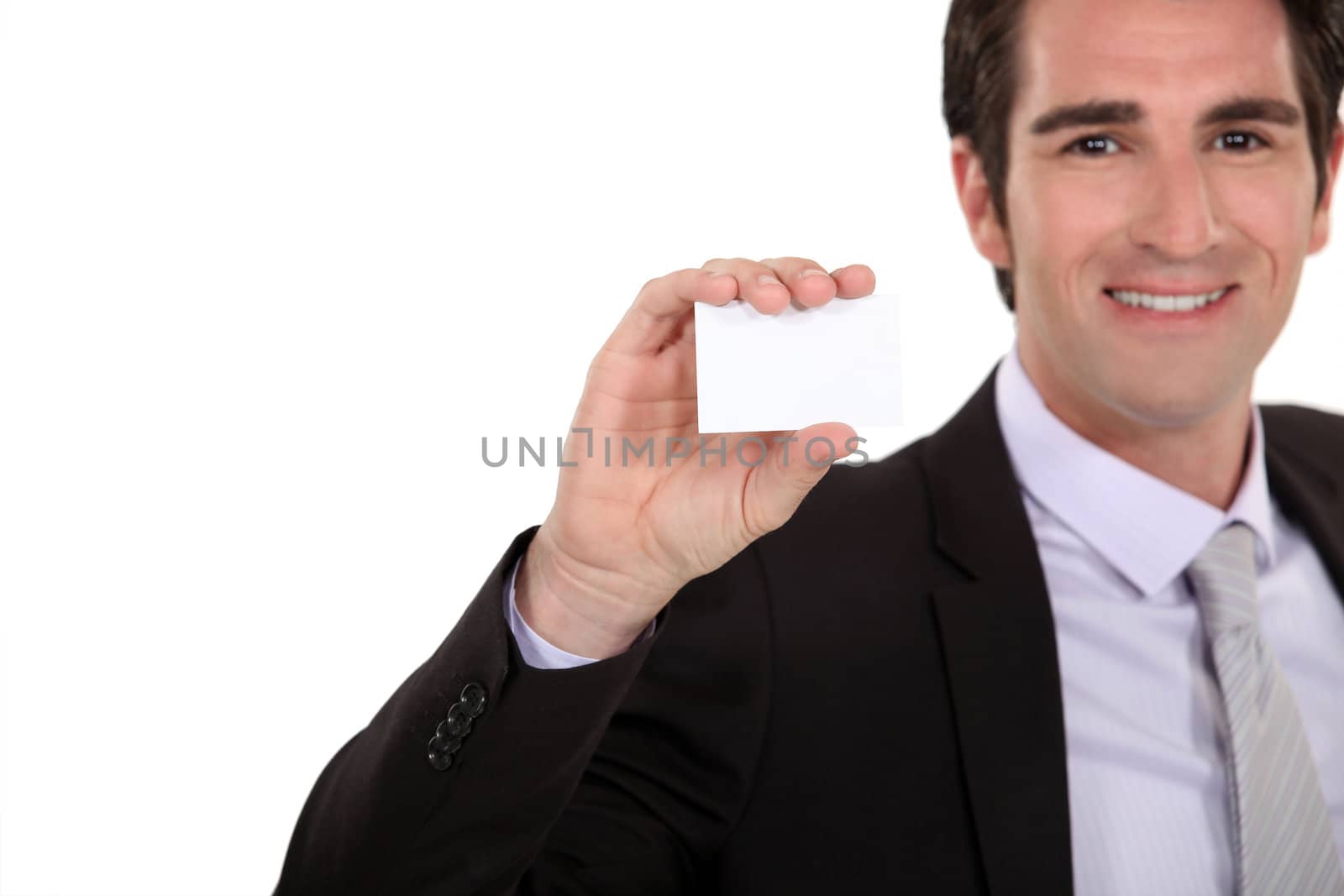 Confident businessman presenting card by phovoir