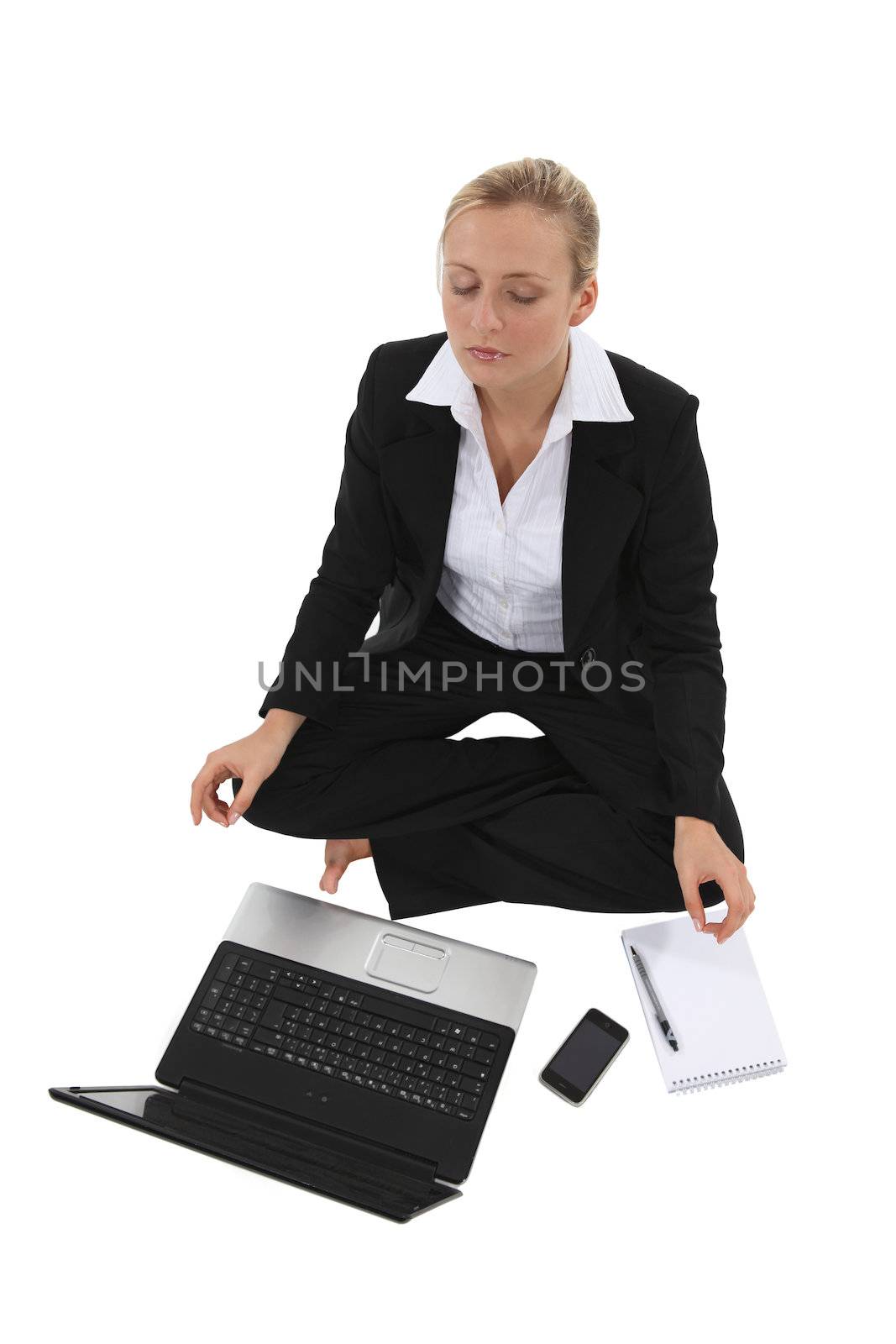 Businesswoman sat in yoga position