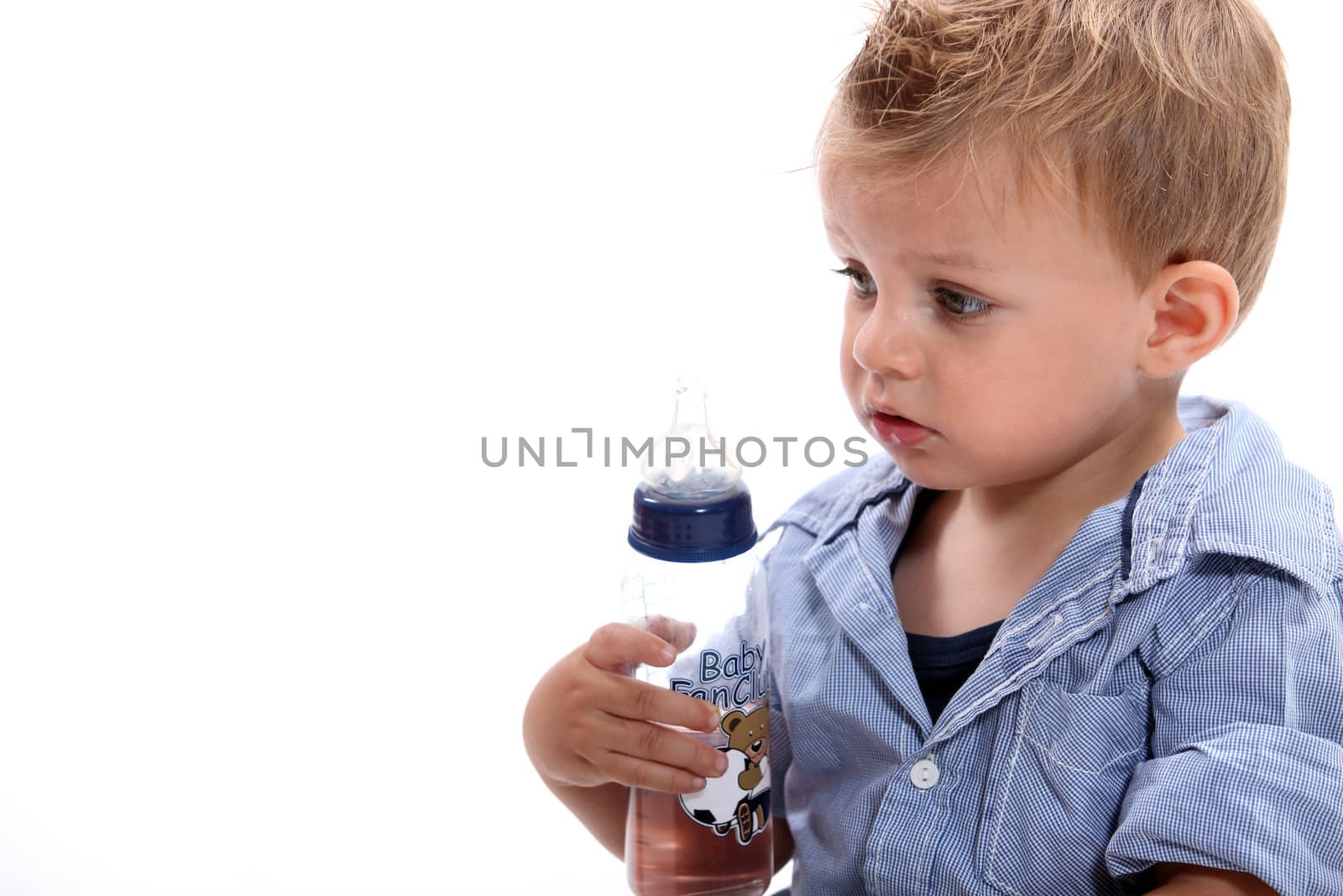 Boy holding bottle by phovoir