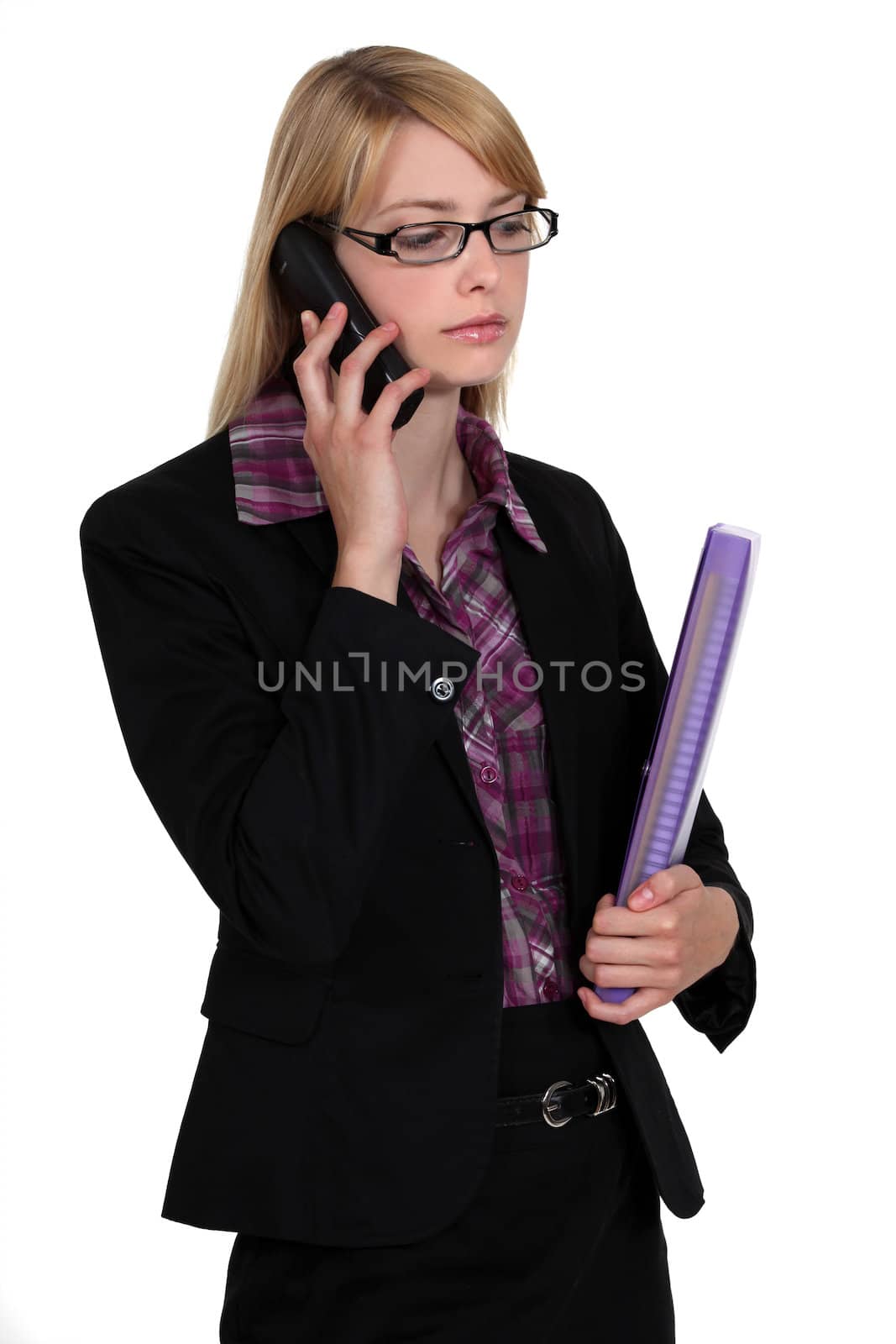 Employee listening to message on her phone by phovoir