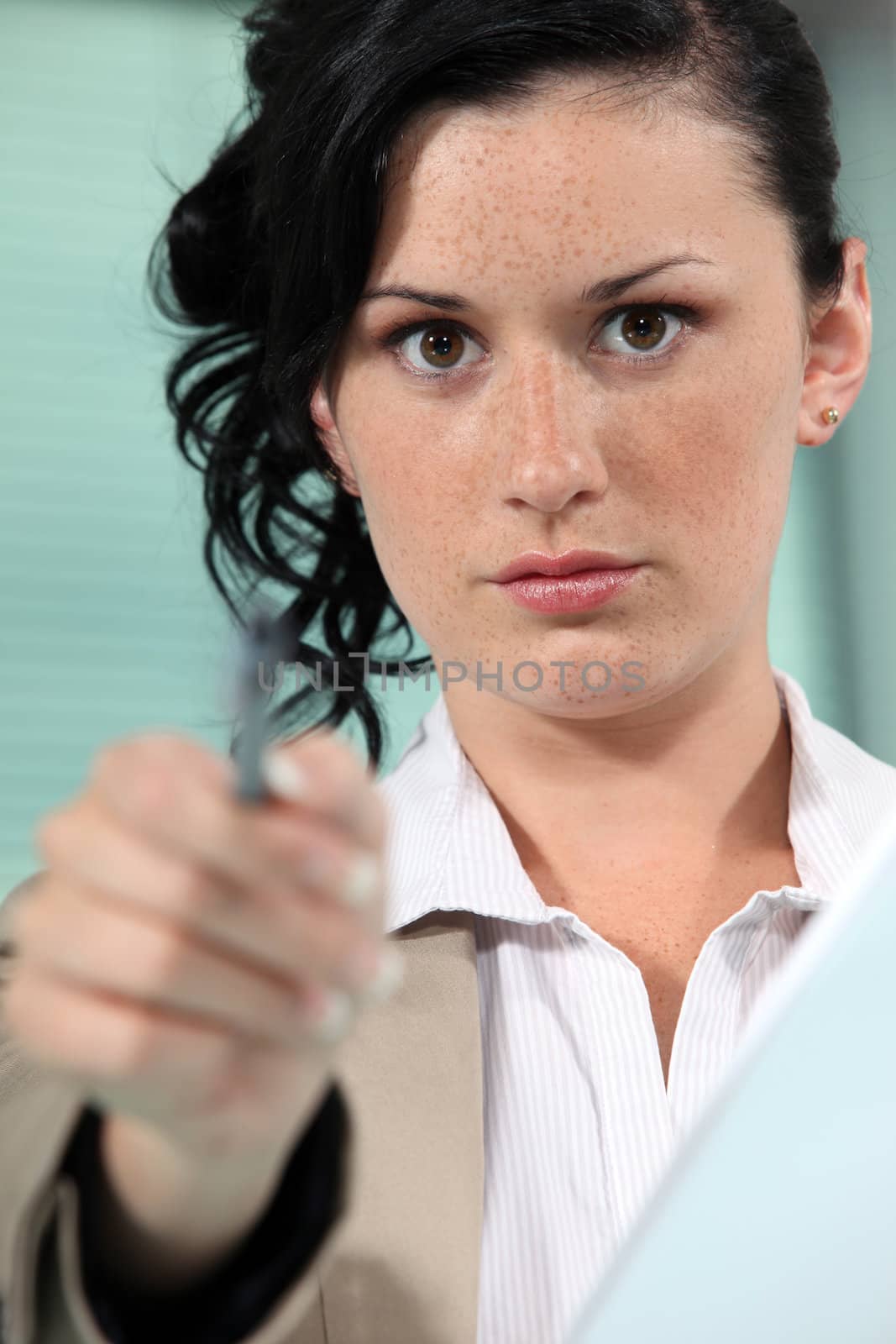 Close-up shot of a woman pointing her pen