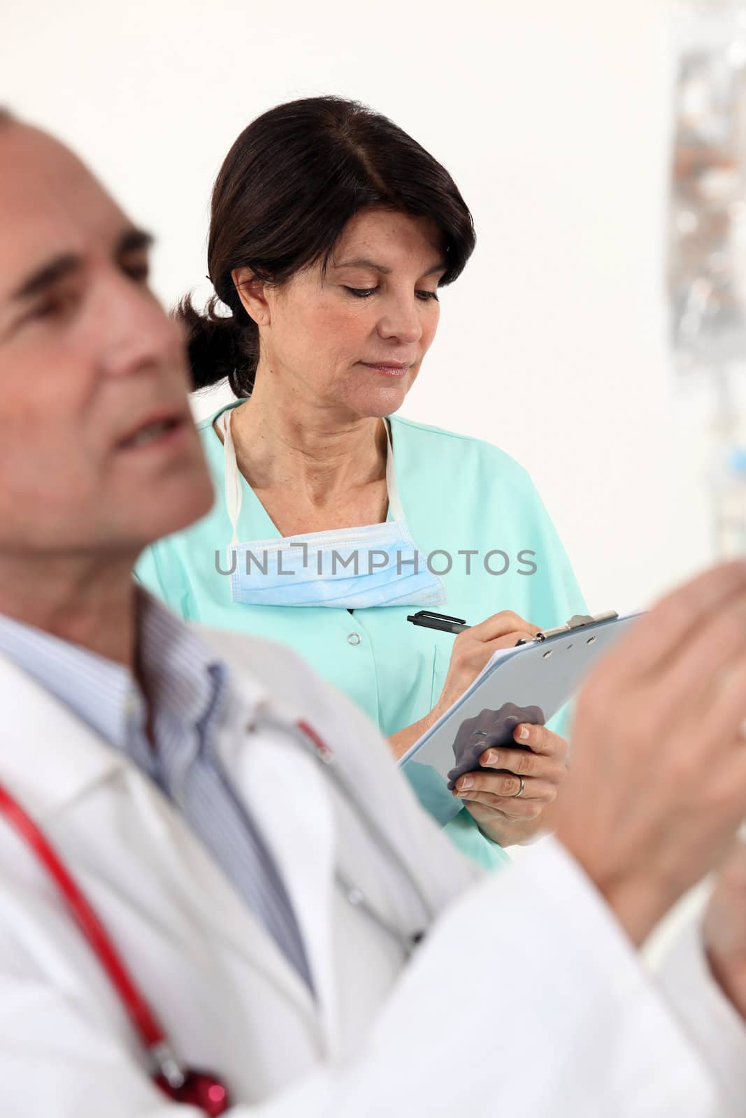 doctor and nurse on a professional meeting by phovoir