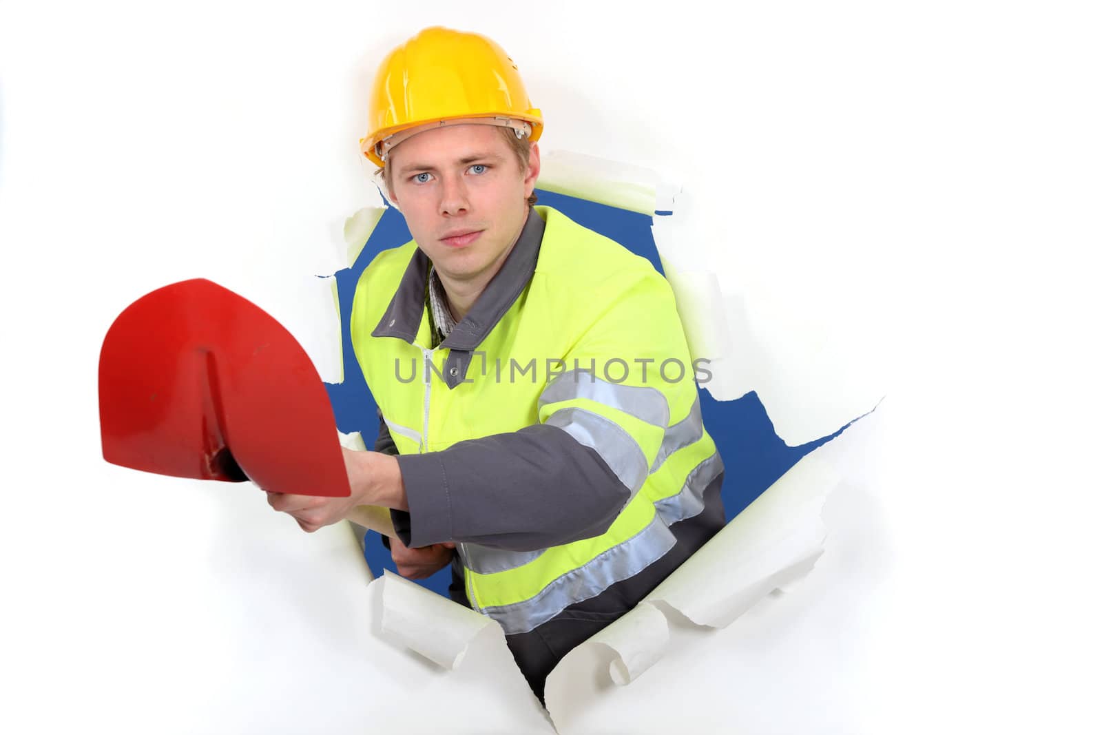 portrait of cute bricklayer with shovel by phovoir