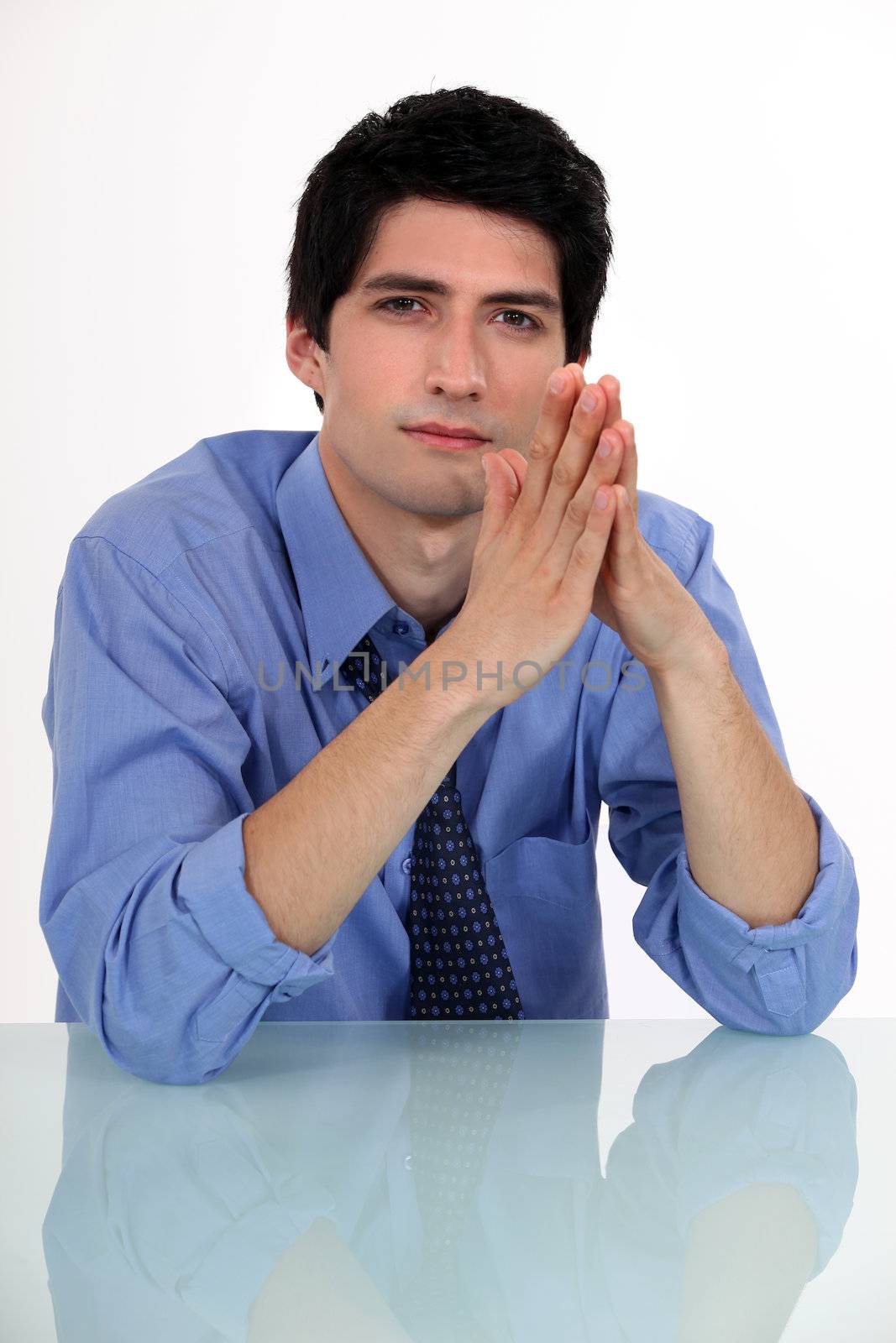 Businessman with his hands pressed together