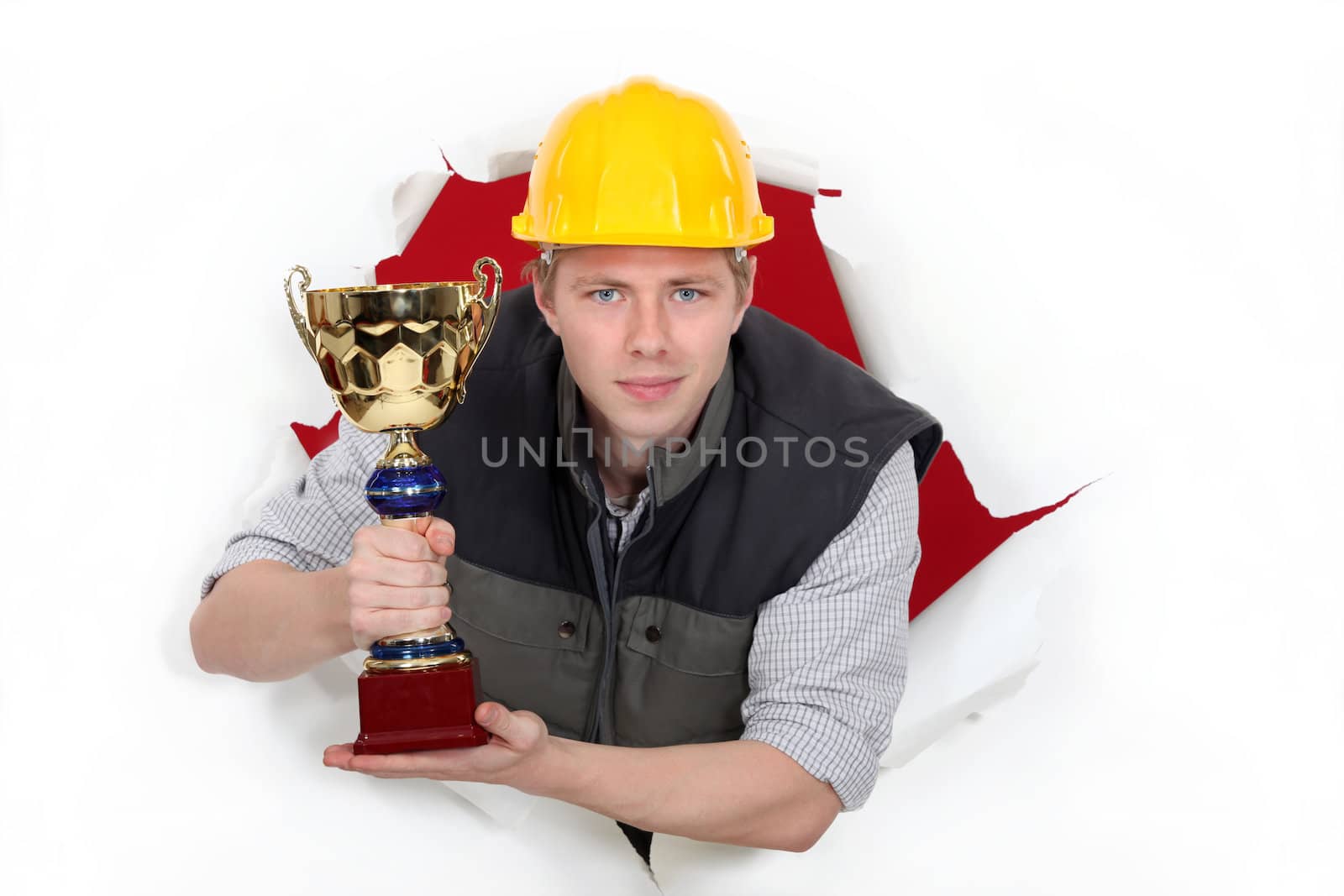 Worker holding a trophy cup.