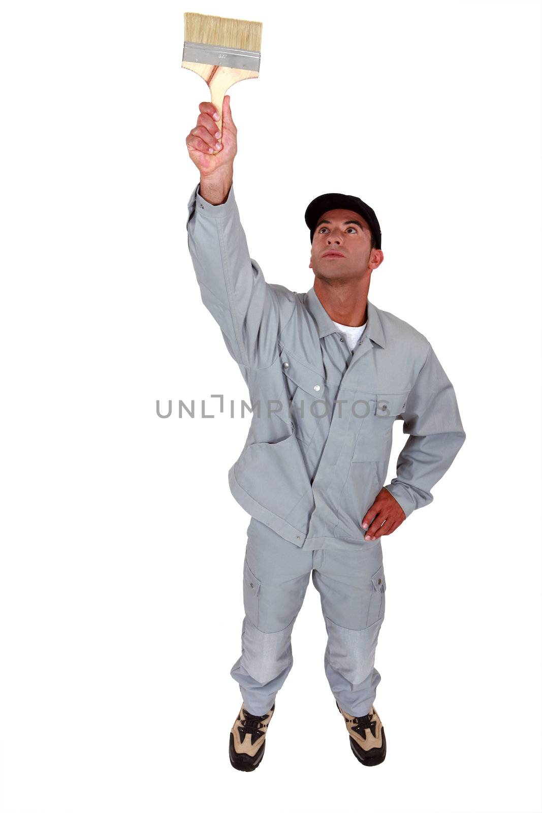 Man painting ceiling with large brush