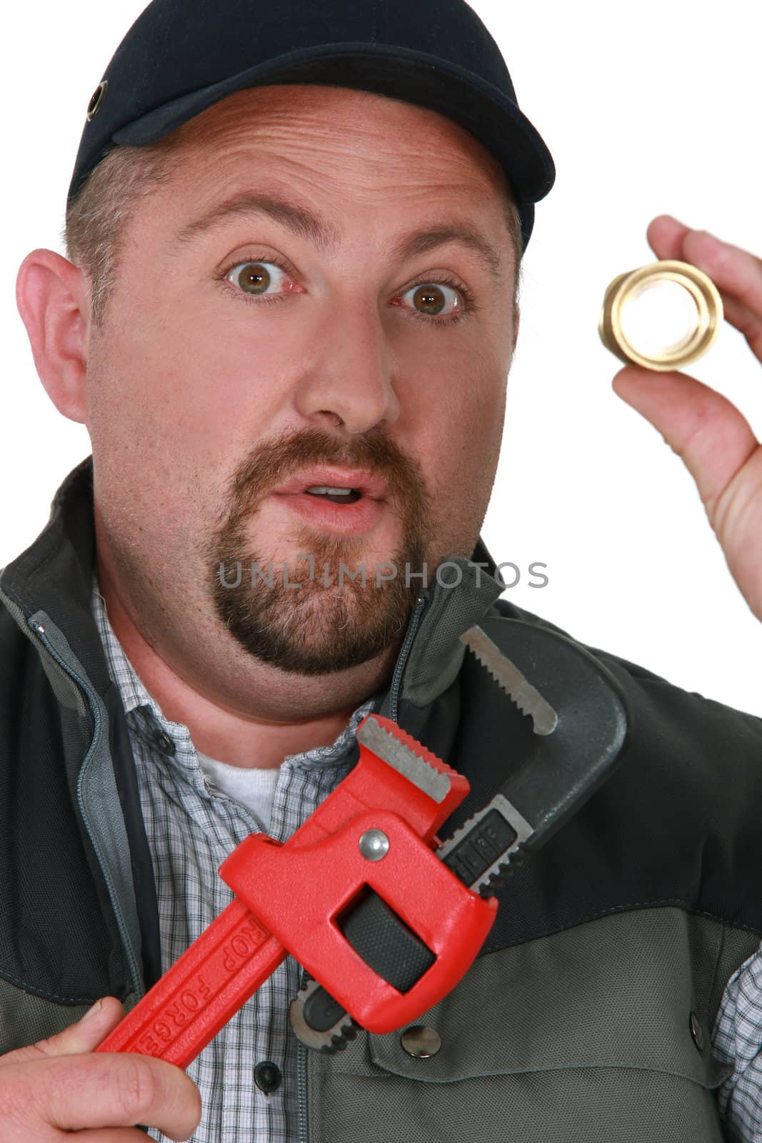 craftsman holding a metal piece and a wrench