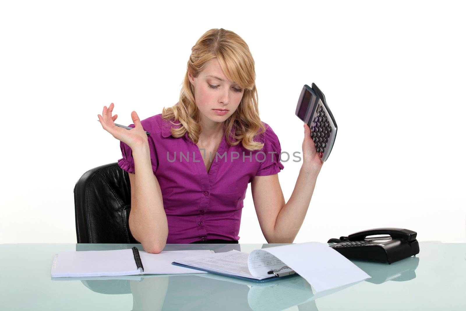 Frustrated woman working out a budget by phovoir