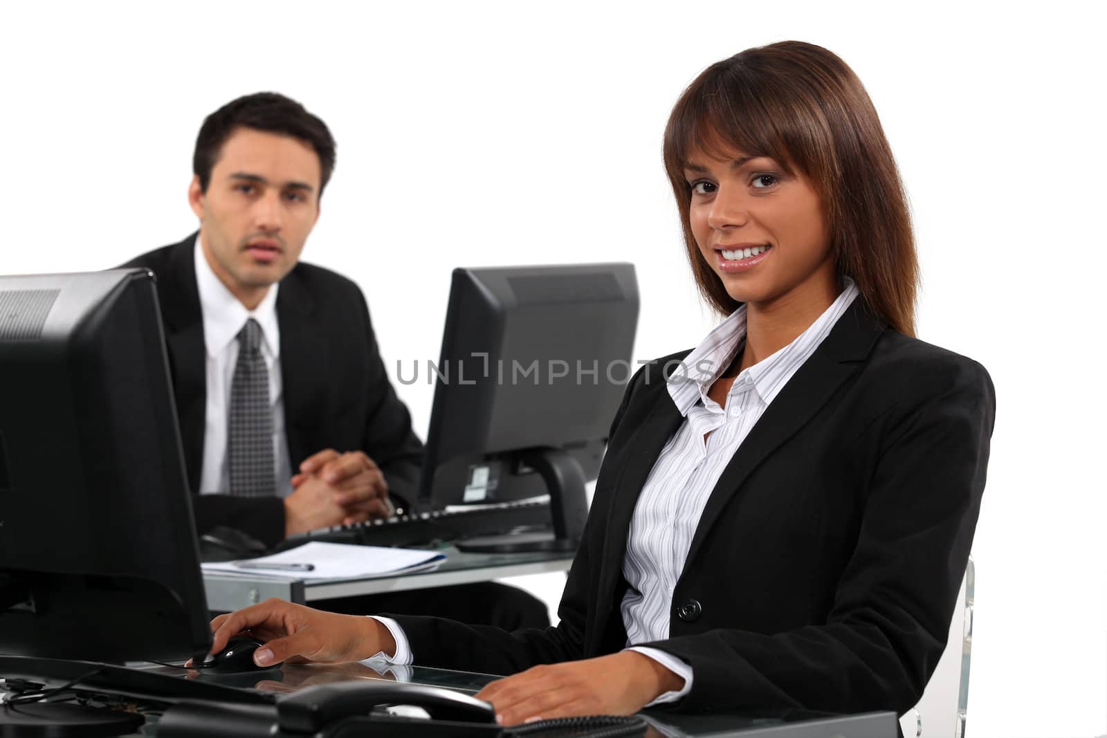 Business professionals working behind their desks