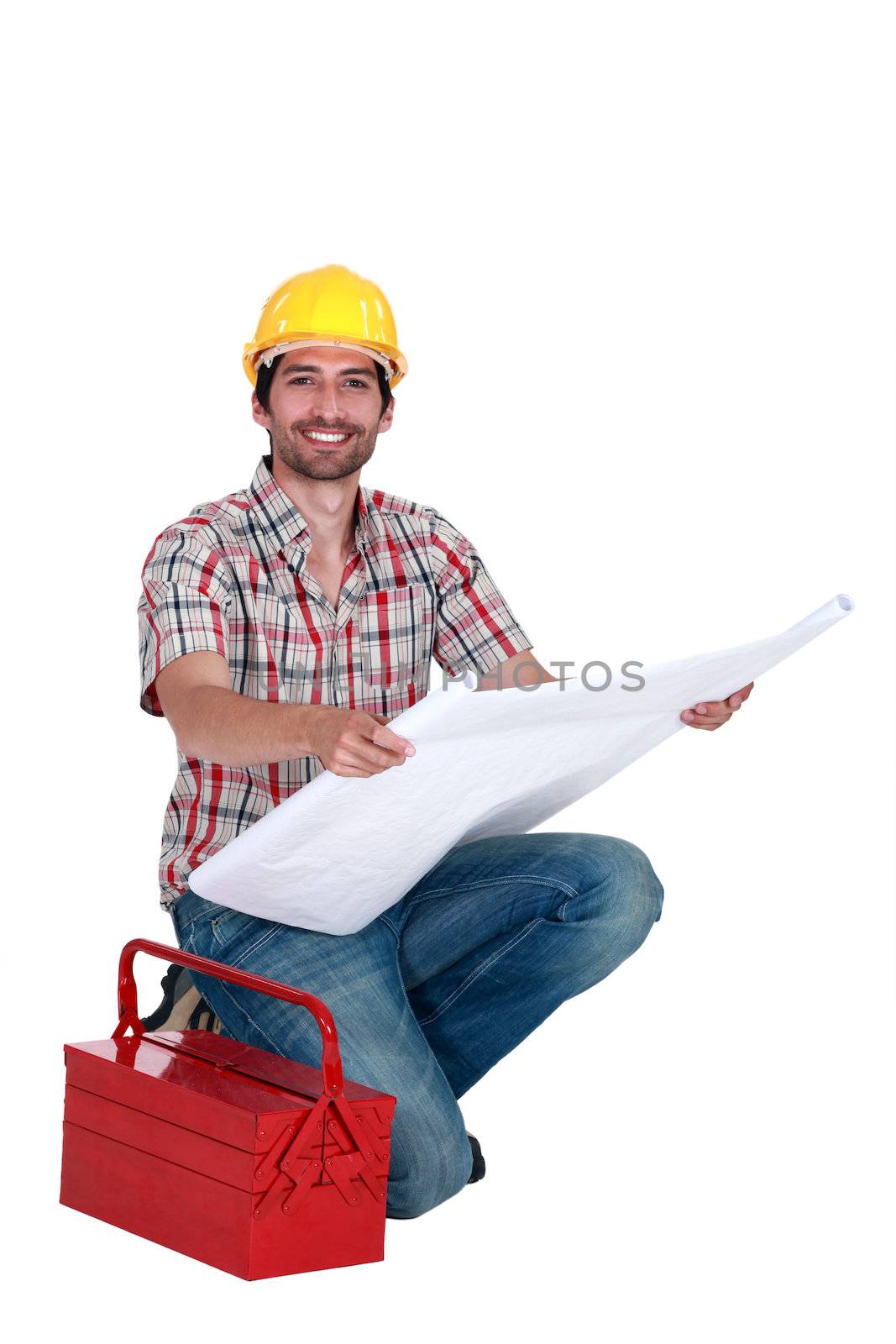 Happy foreman observing a blueprint