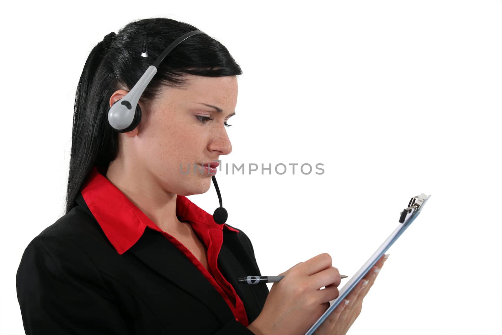 Office assistant writing on a clipboard