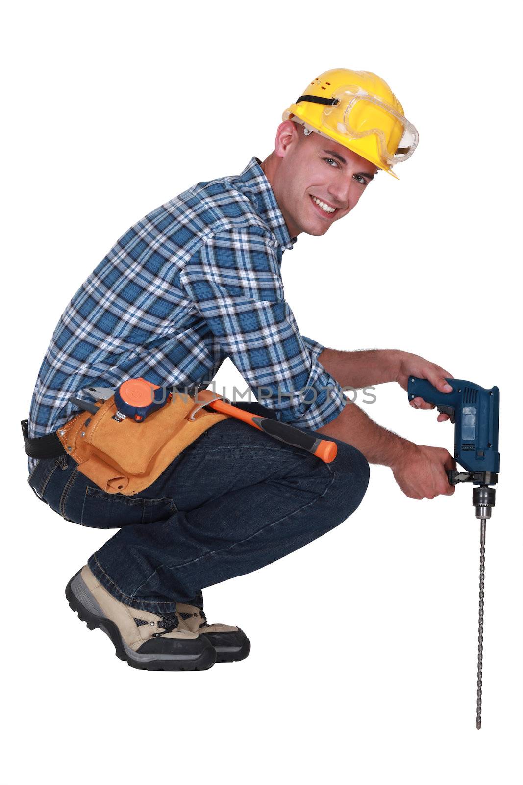 Tradesman using a power tool with a long bit